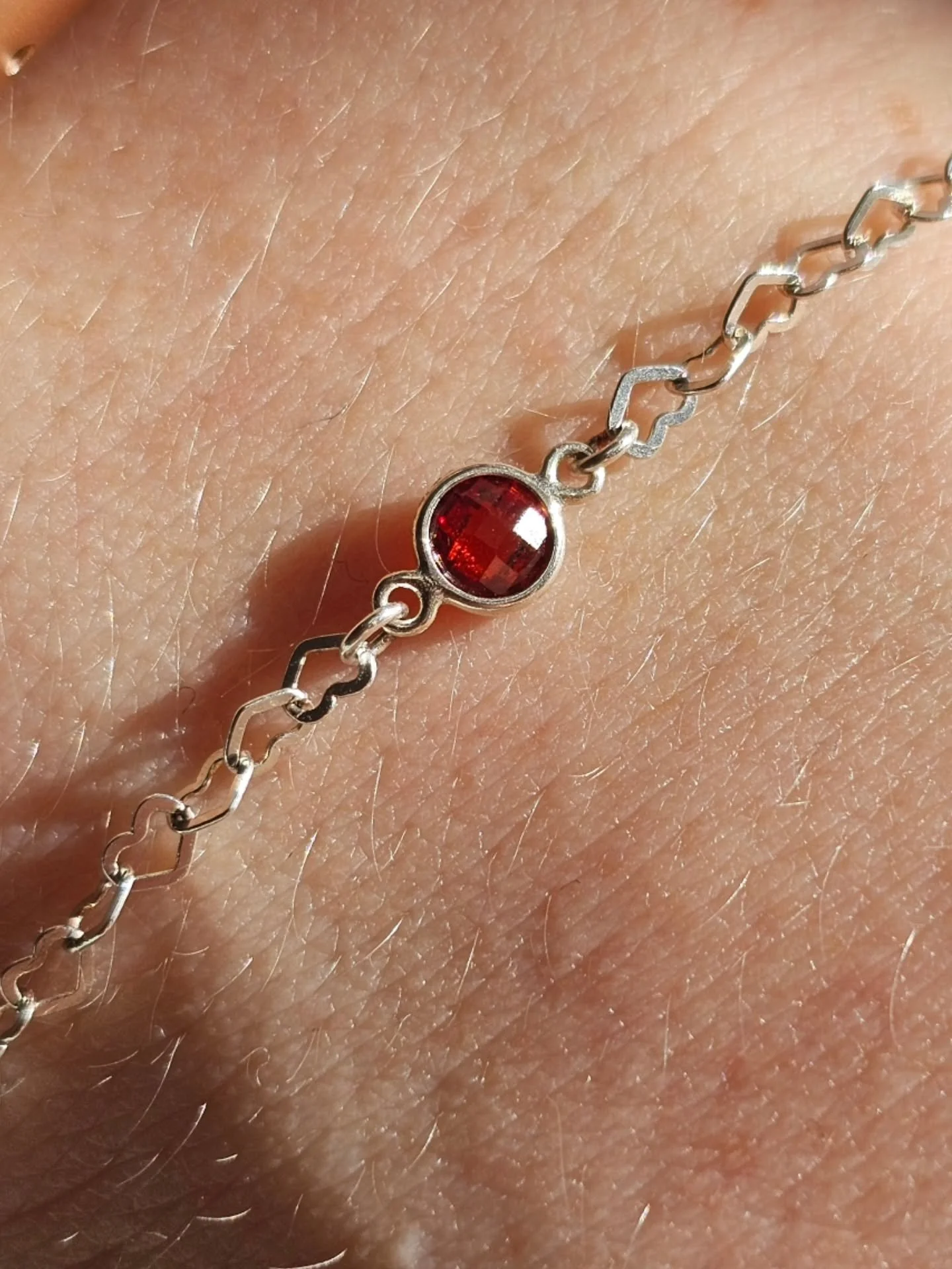A beautiful Sterling Silver permanent bracelet created this morning... a celebration of a beautiful baby girl ~ the heart chain to symbolise love and the sparkling rich red connector charm to celebrate her January birthstone of Garnet ❤️❤️❤️ Thank Yo