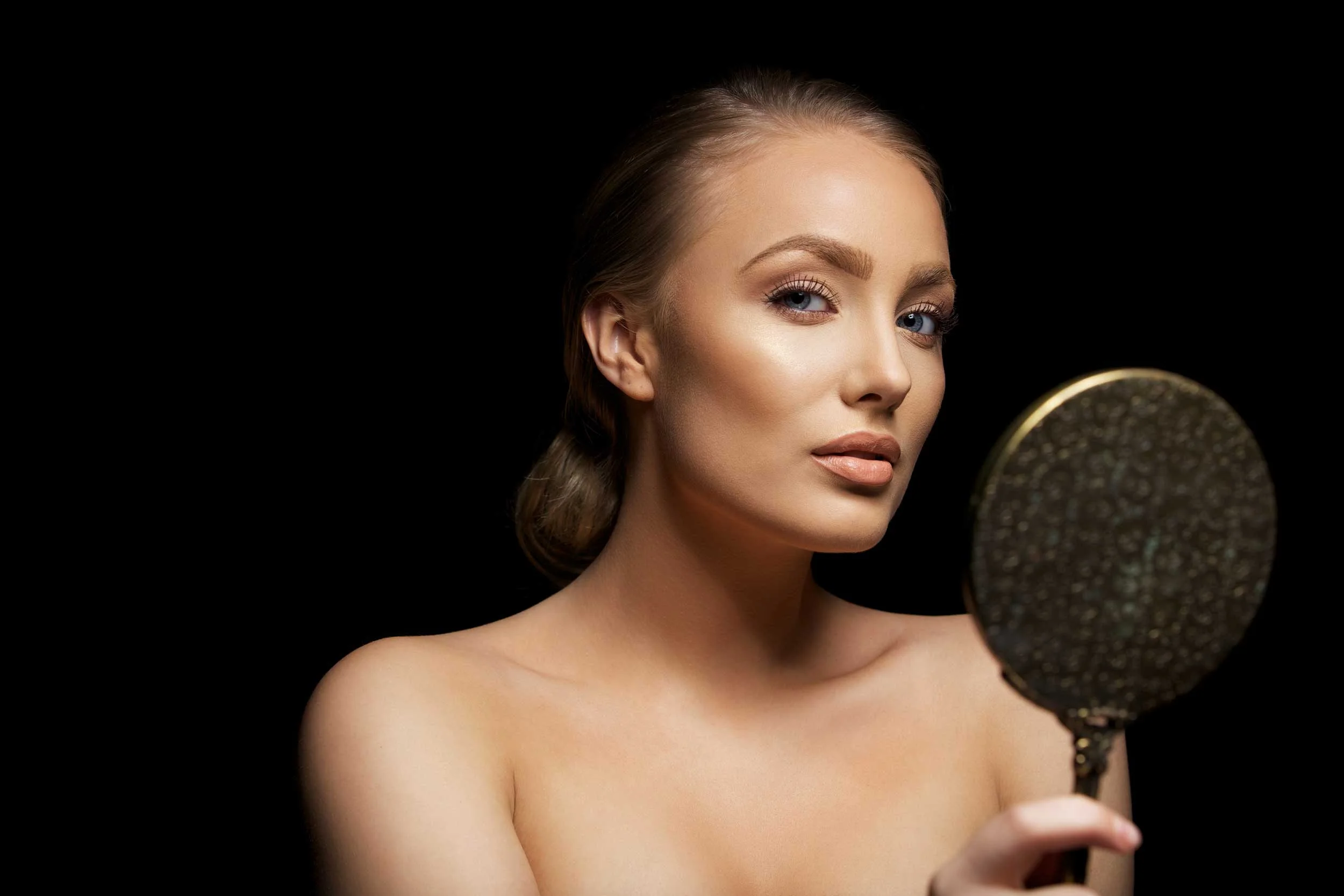 portrait-of-attractive-young-female-model-holding-a-hand-mirror-looking-at-camera-sexy-young-woman-against-black-background_SpgUBELEFg.jpg