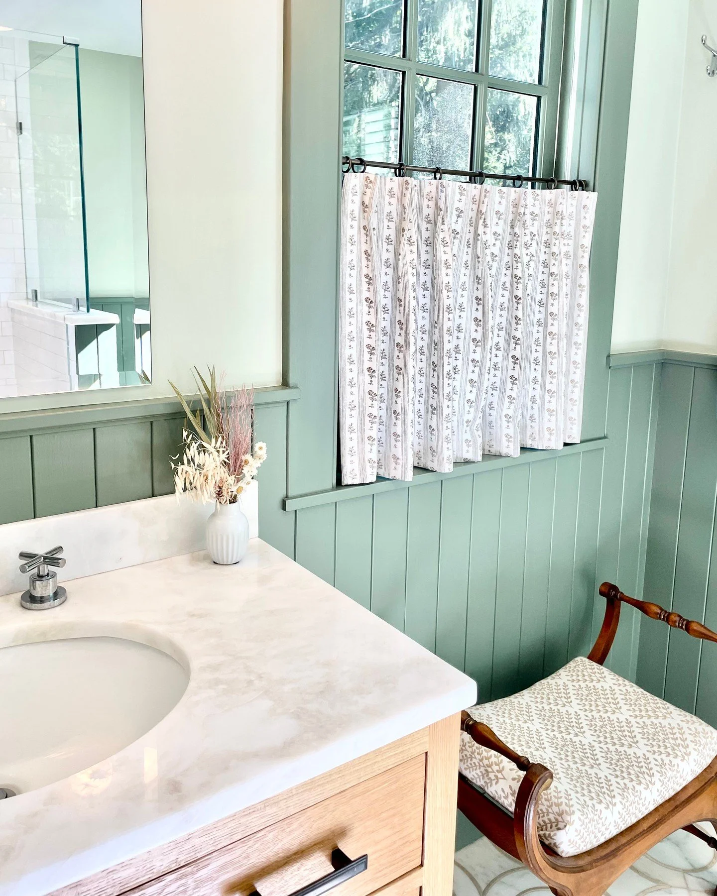 Old soul meets fresh style in this expanded primary bathroom.  This client loves blending old and new and every project we work together on is layered and charming.  I totally think that cafe curtains are having a moment right now.  What do you think
