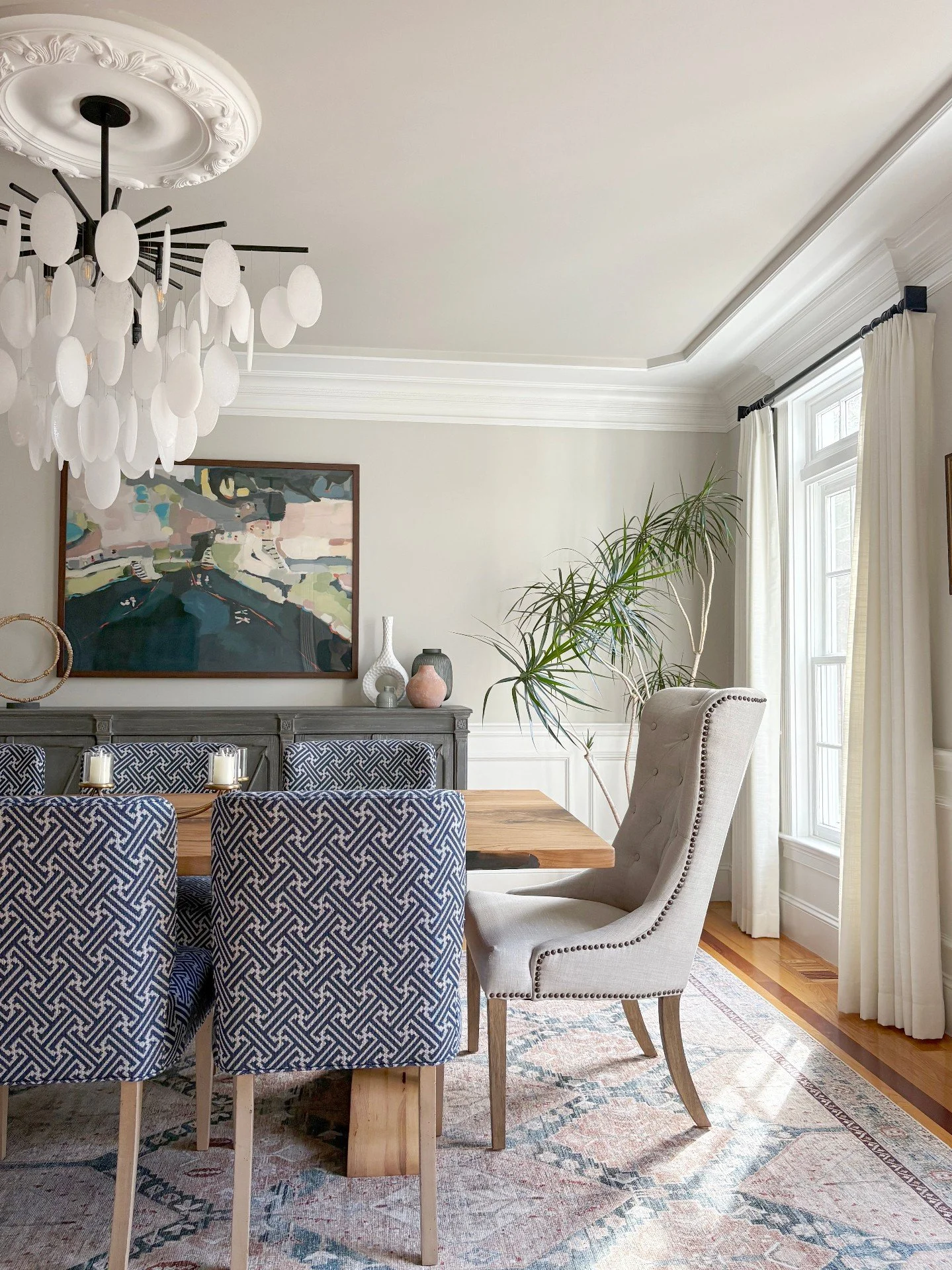 It's that time of year when having a finished dining room really pays off, and you can't wait to fill it with family and friends! From the sculptural chandelier to the patterned seating and modern art, every detail plays together to make gatherings f