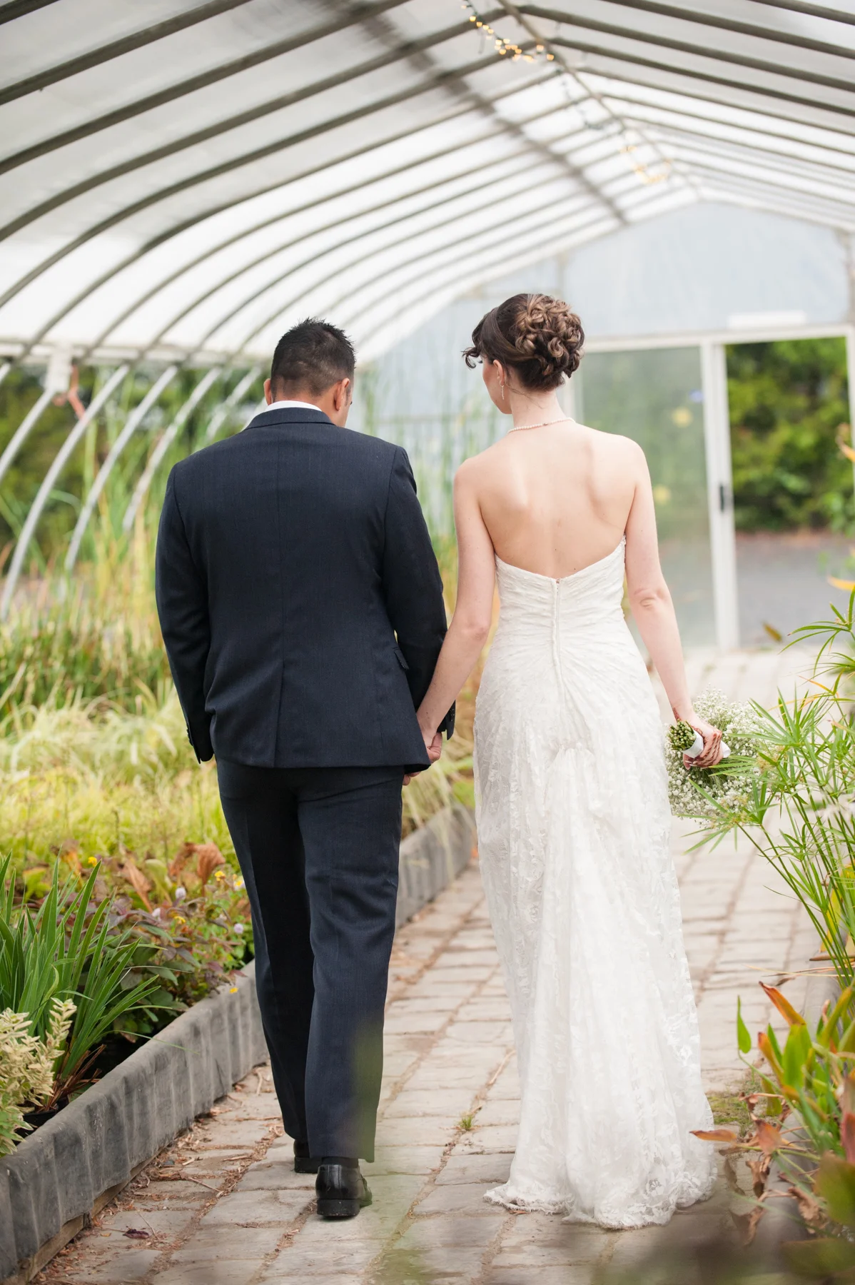 bride and groom holding hands