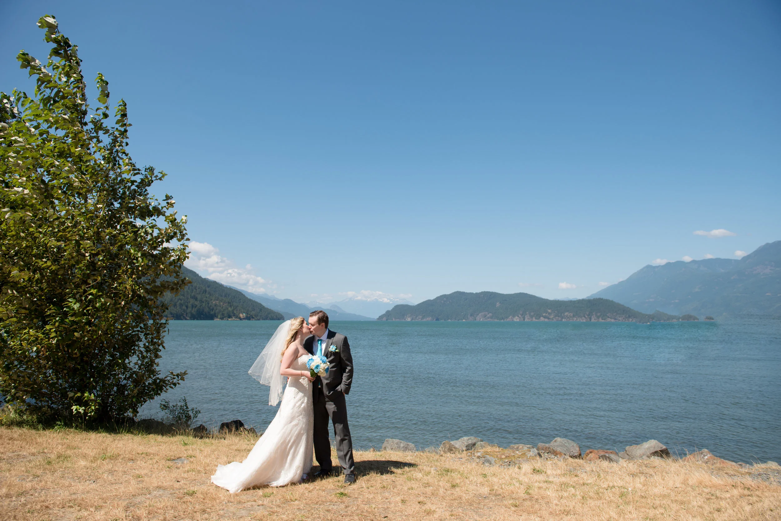 Harrison wedding Bride and groom standing by the lake