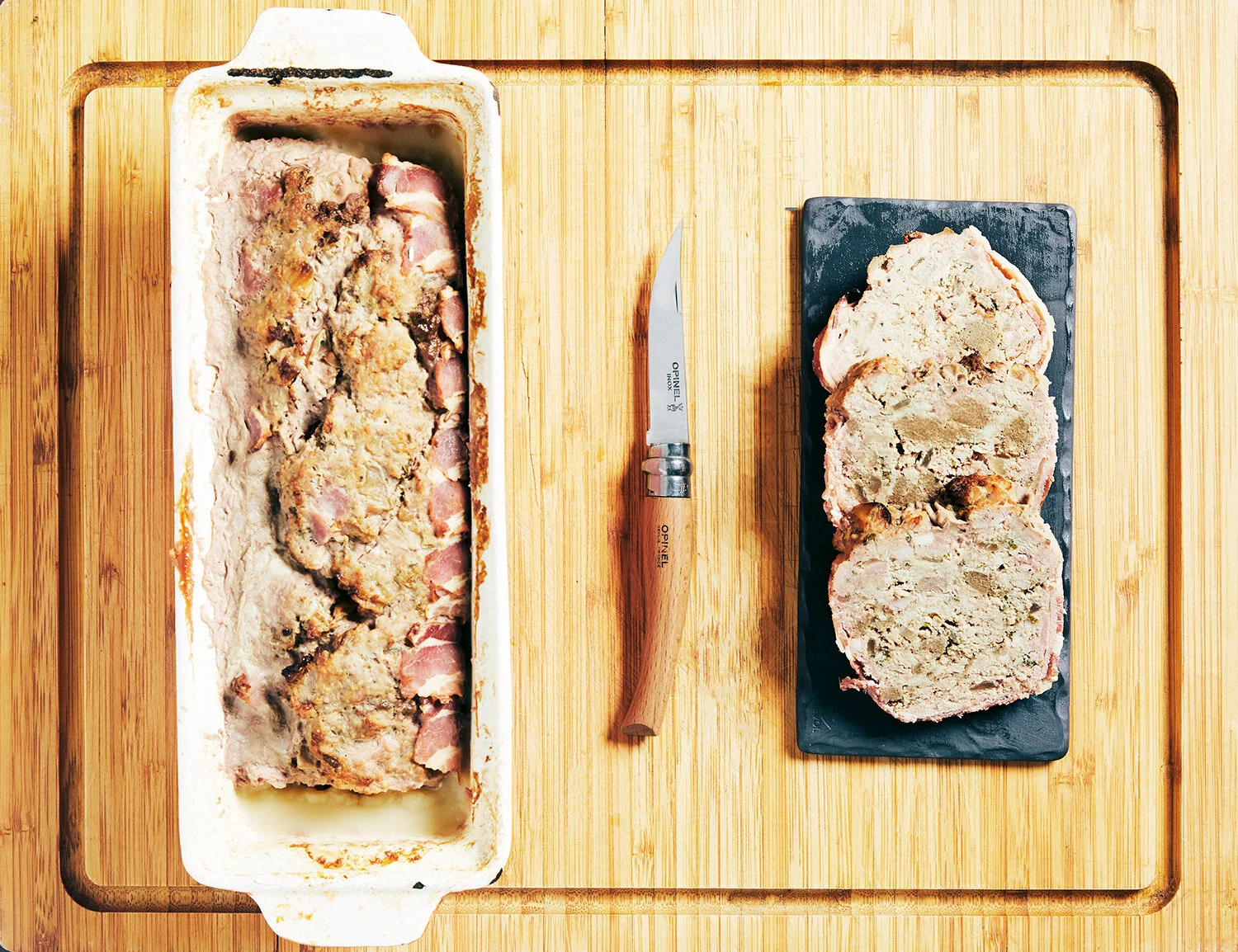Terrine Campagnarde served whole with servings lined up on a small slate 