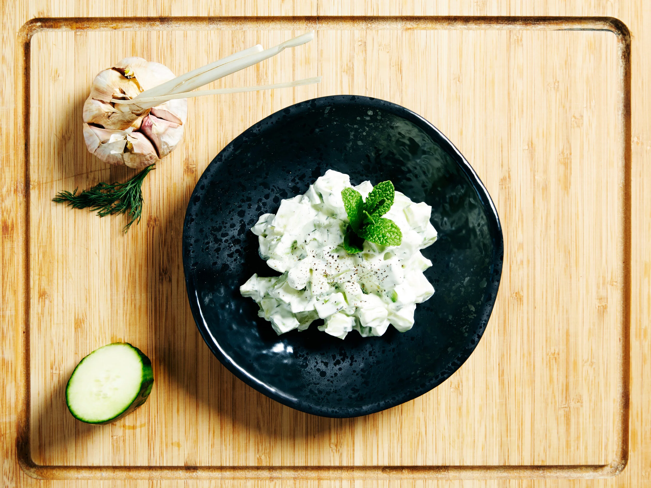 Ja Jahre Cucumber salad served with a slice of cucumber and bulb of garlic (Copy)
