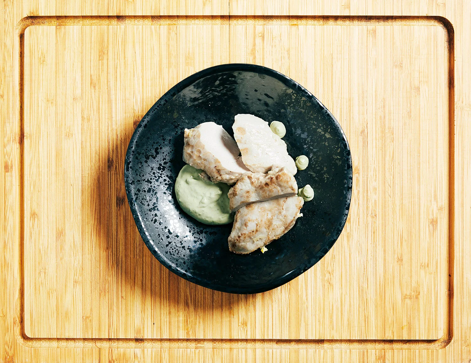 Chicken and wild garlic cream served on a wooden board  (Copy)