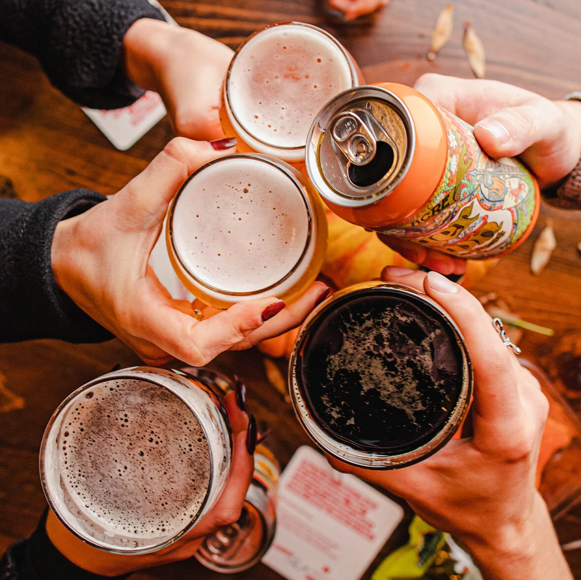 Group of people holding beers and clinking glasses.jpg