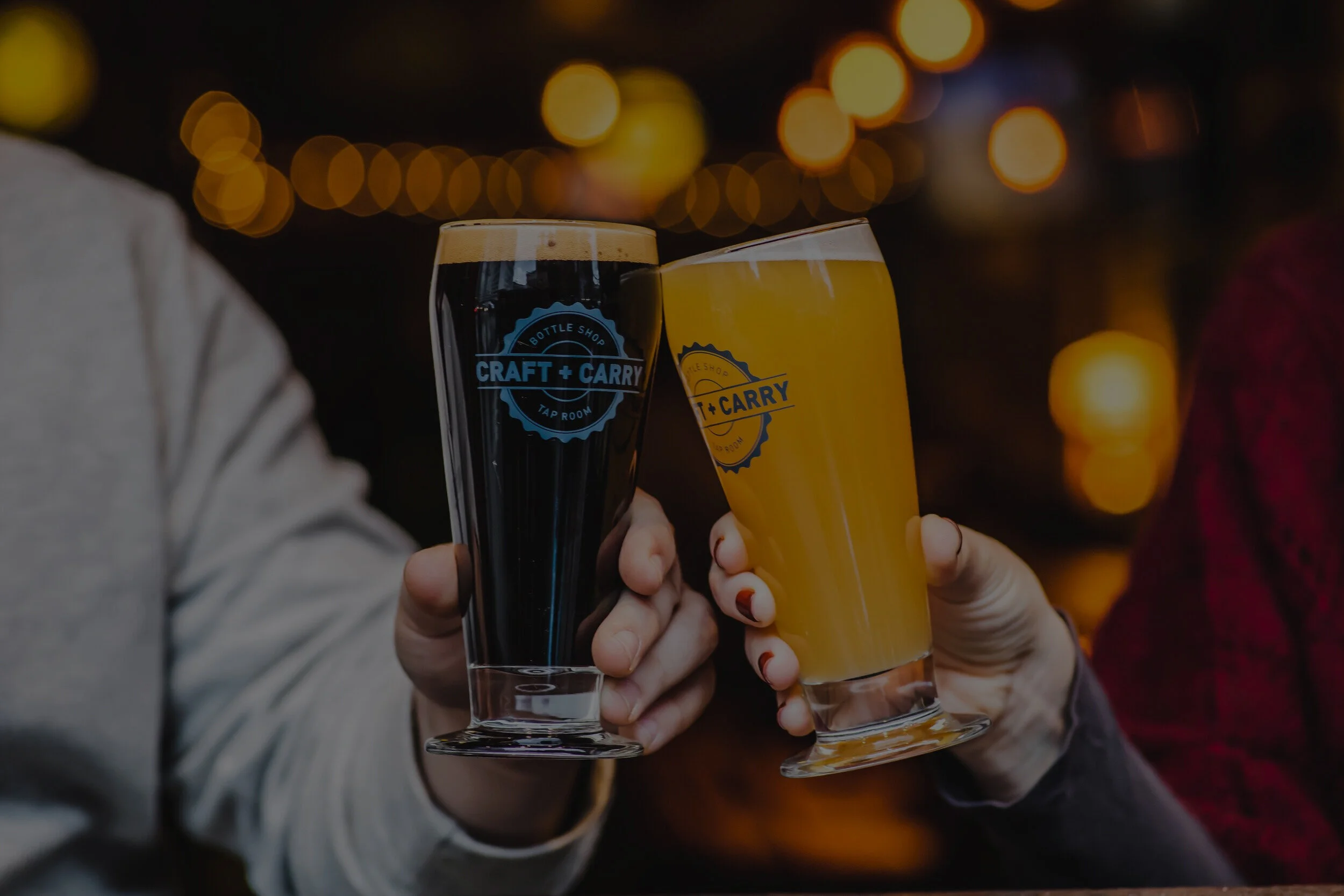 Two people holding beers and clinking glasses.jpg
