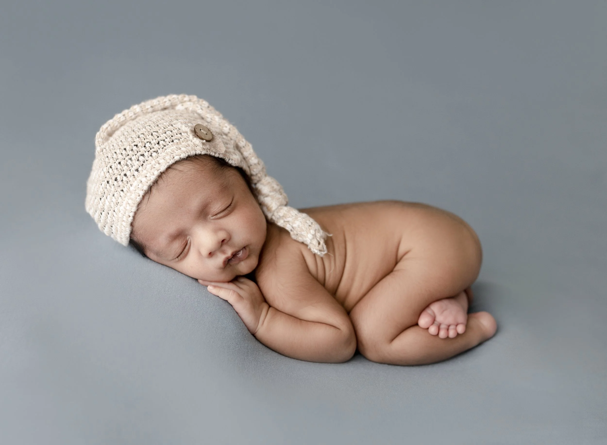 baby-on-blue-blanket-sleepy-cap.jpg