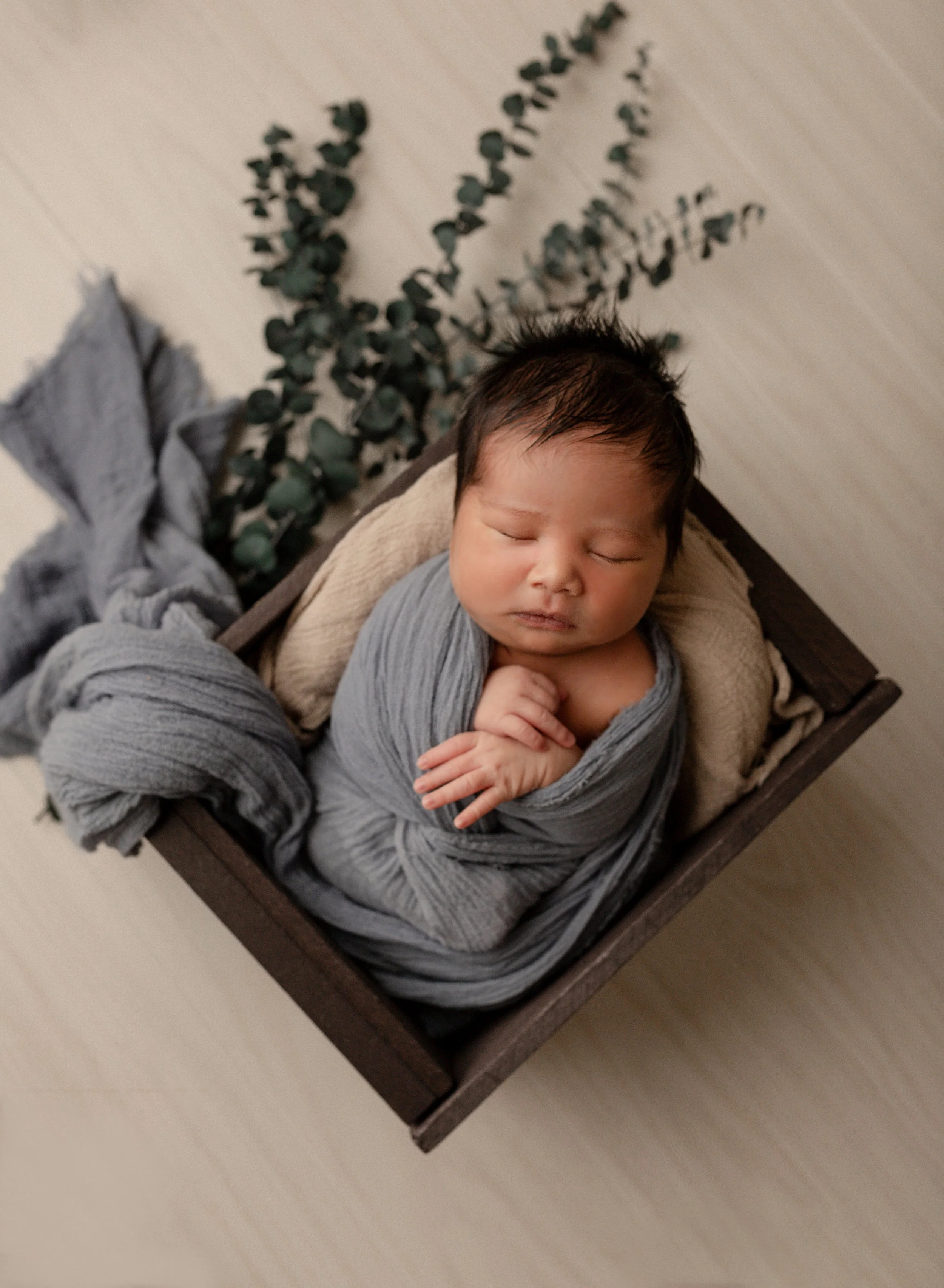 lots-of-hair-newborn-boy-in-blue.jpg
