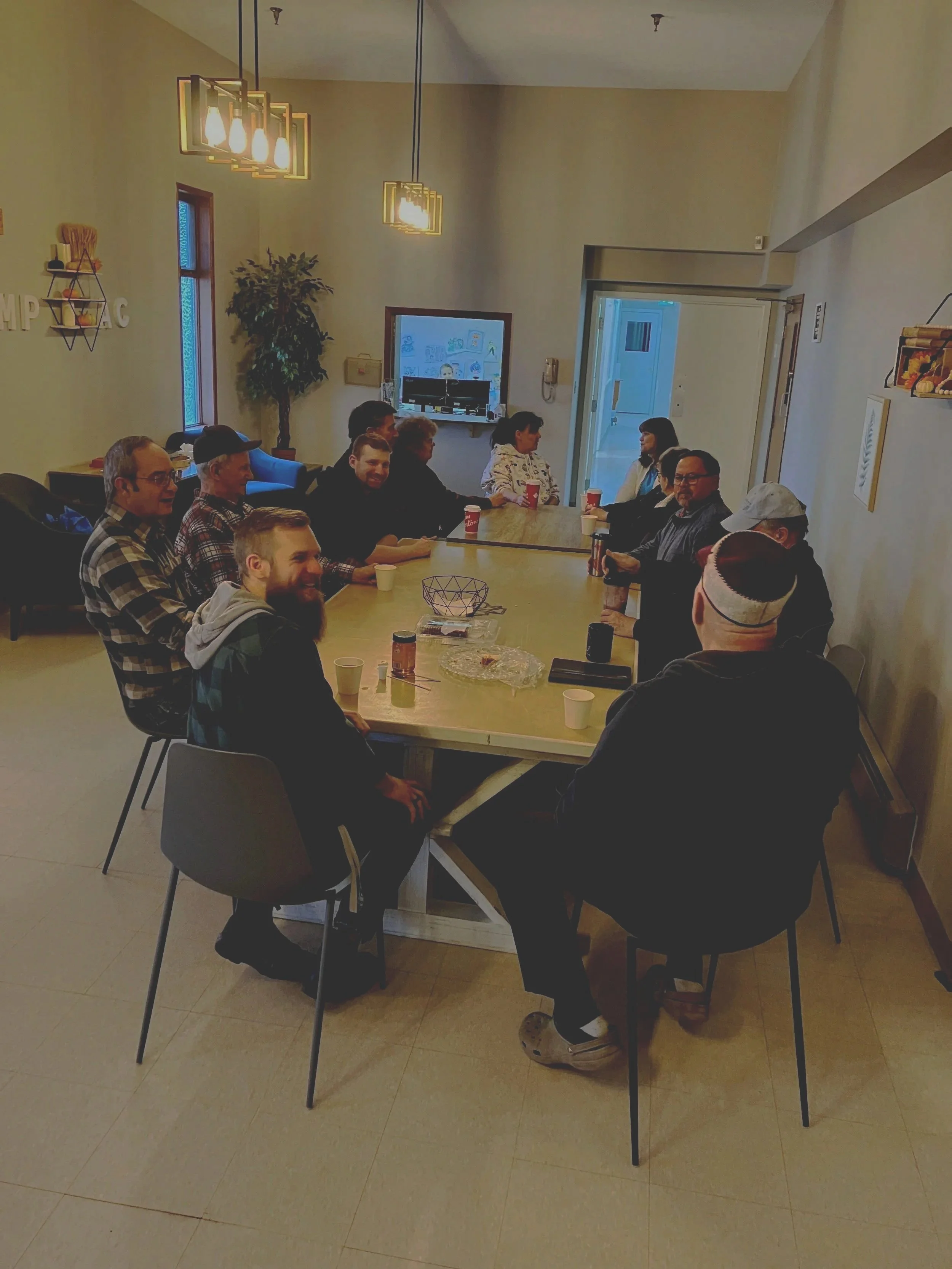 having coffee and talking around a table
