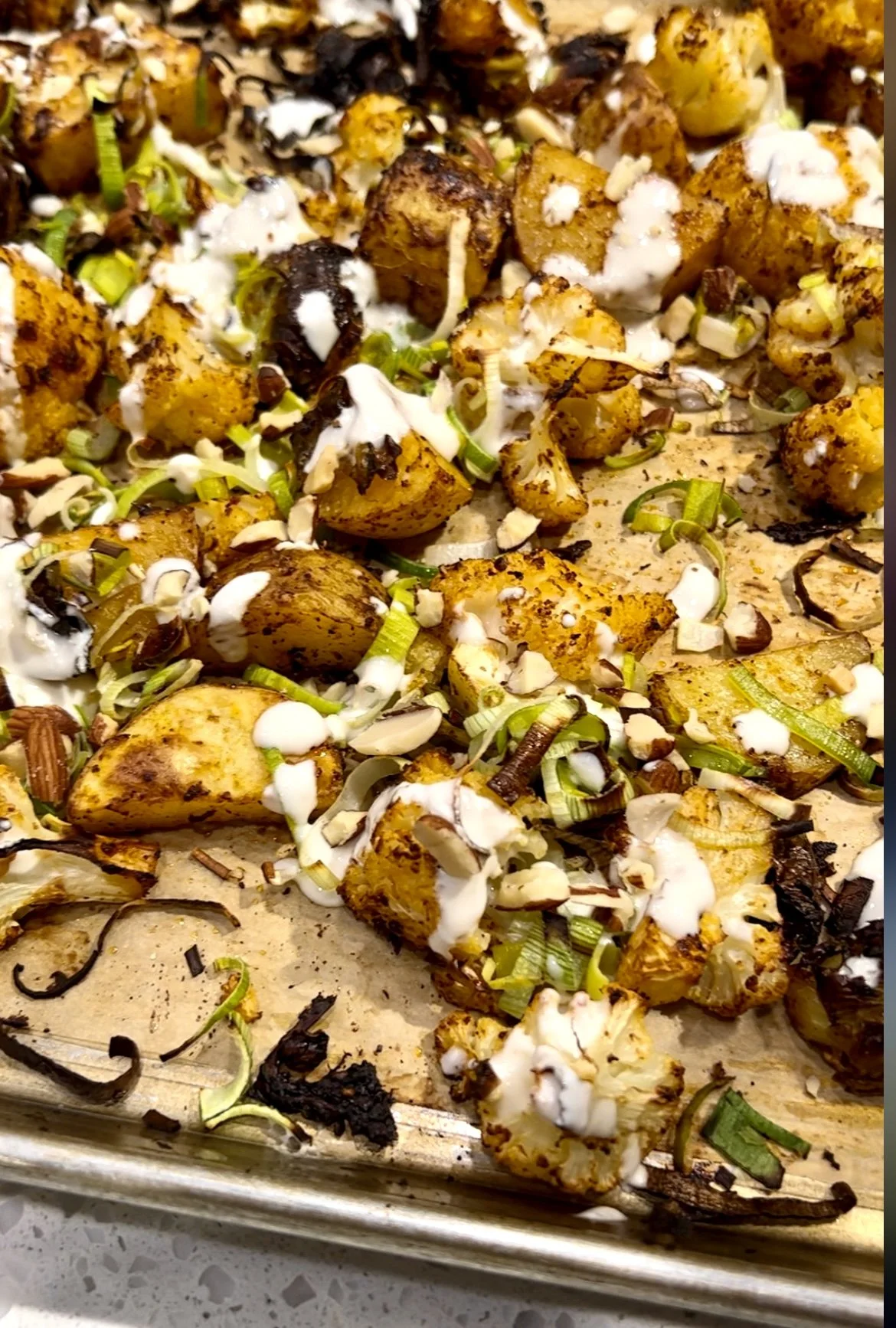 Roasted Cauliflower, Potatoes and Brussel Sprouts   with Harissa, Yogurt, and Toasted Almonds