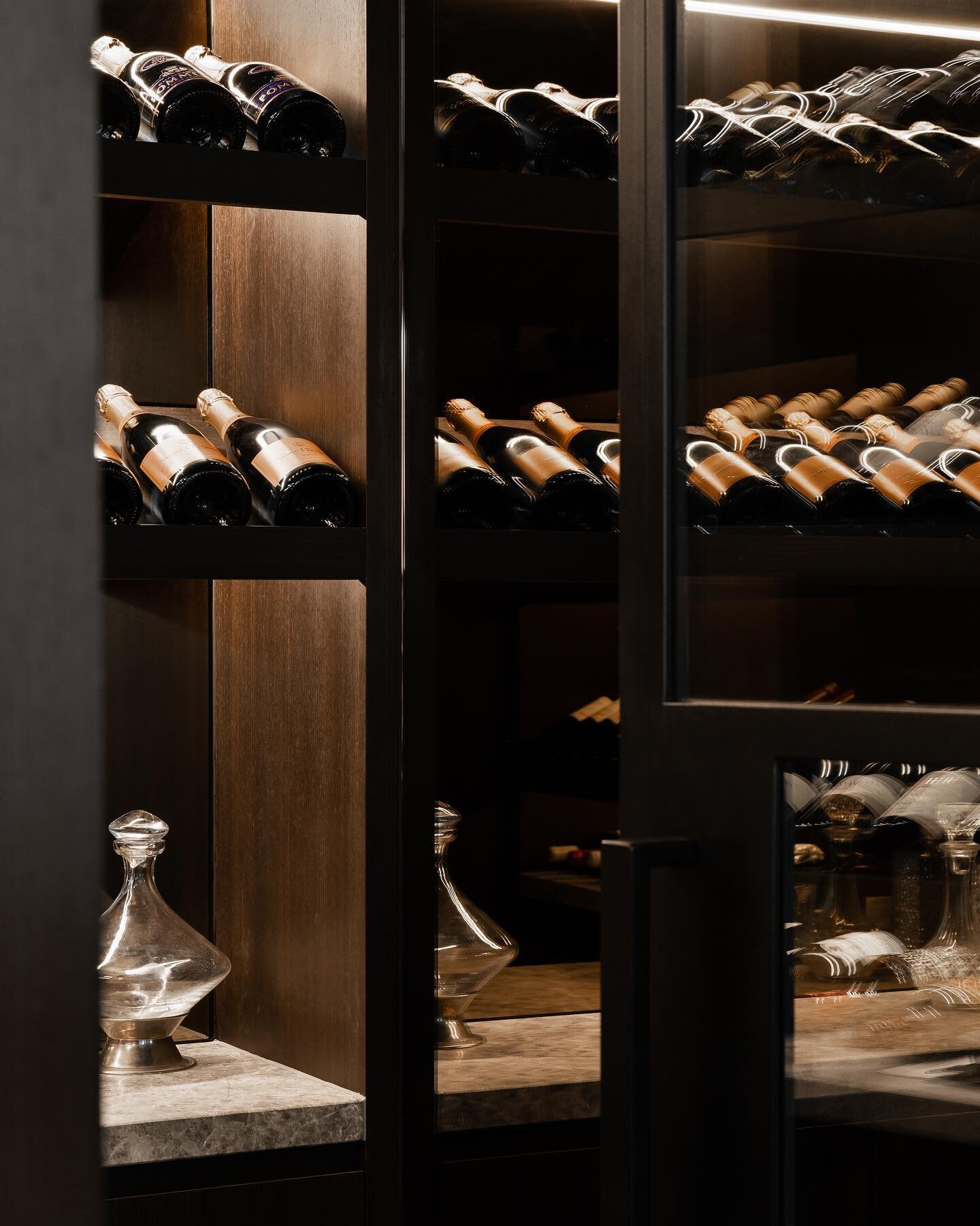 Sitting behind a custom steel door with refrigerated conditions our #ParkCellar project effortlessly showcases our client&rsquo;s wine collection- perched on chocolate veneer shelves and limestone, lit with a warm glow.