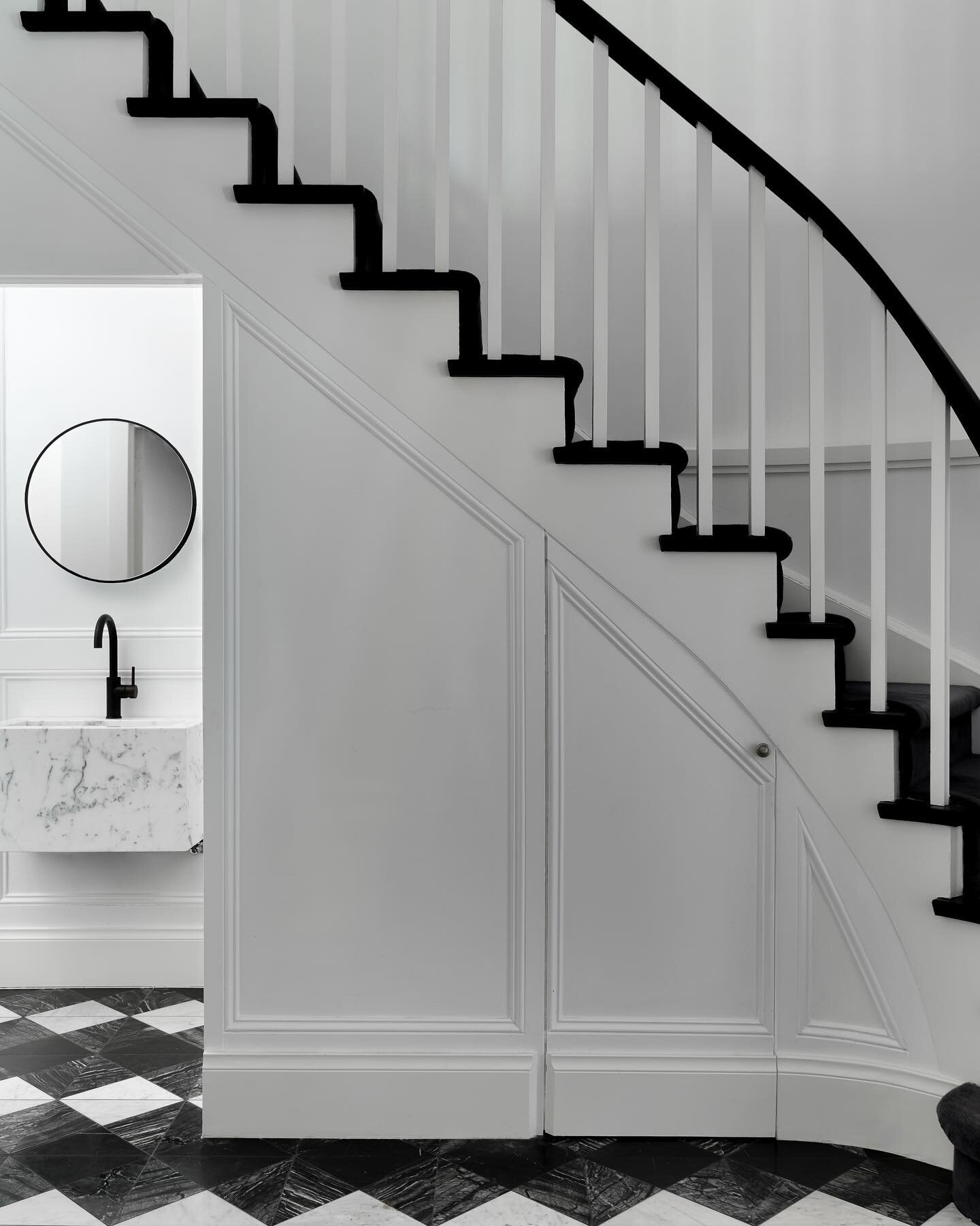 The new classic at #RupertsResidence 🤍&spades;️
Hidden behind the bolection mouldings on the feature staircase you find our hidden powder room. Here we married the bold black and white tiled floor with our custom, hand made Carrara marble basin.