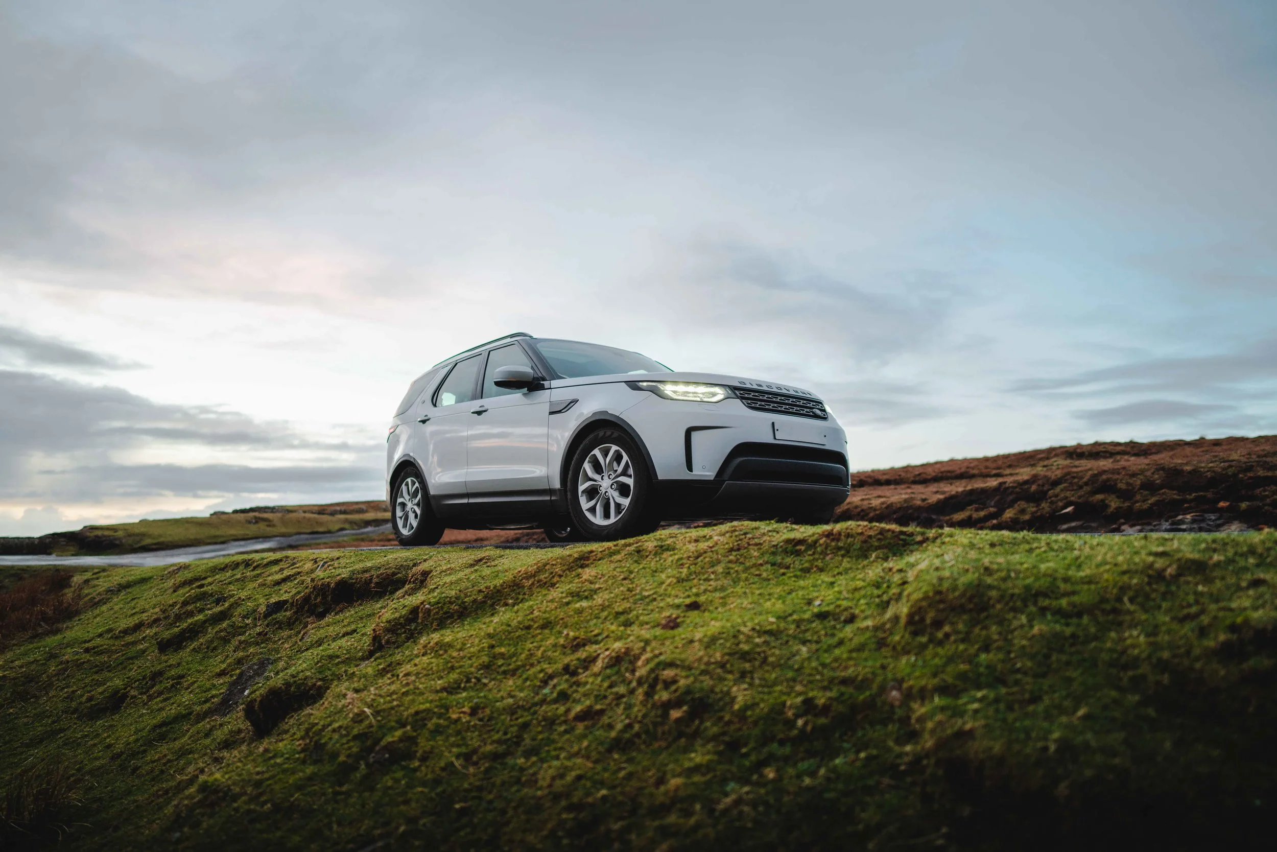 Land Rover Discovery in Scotland by sunset.