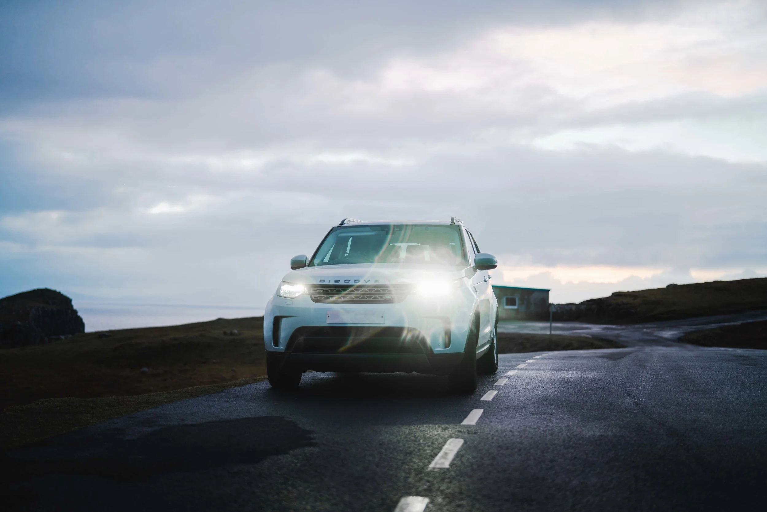 Land Rover Discovery in Scotland with light reflection.