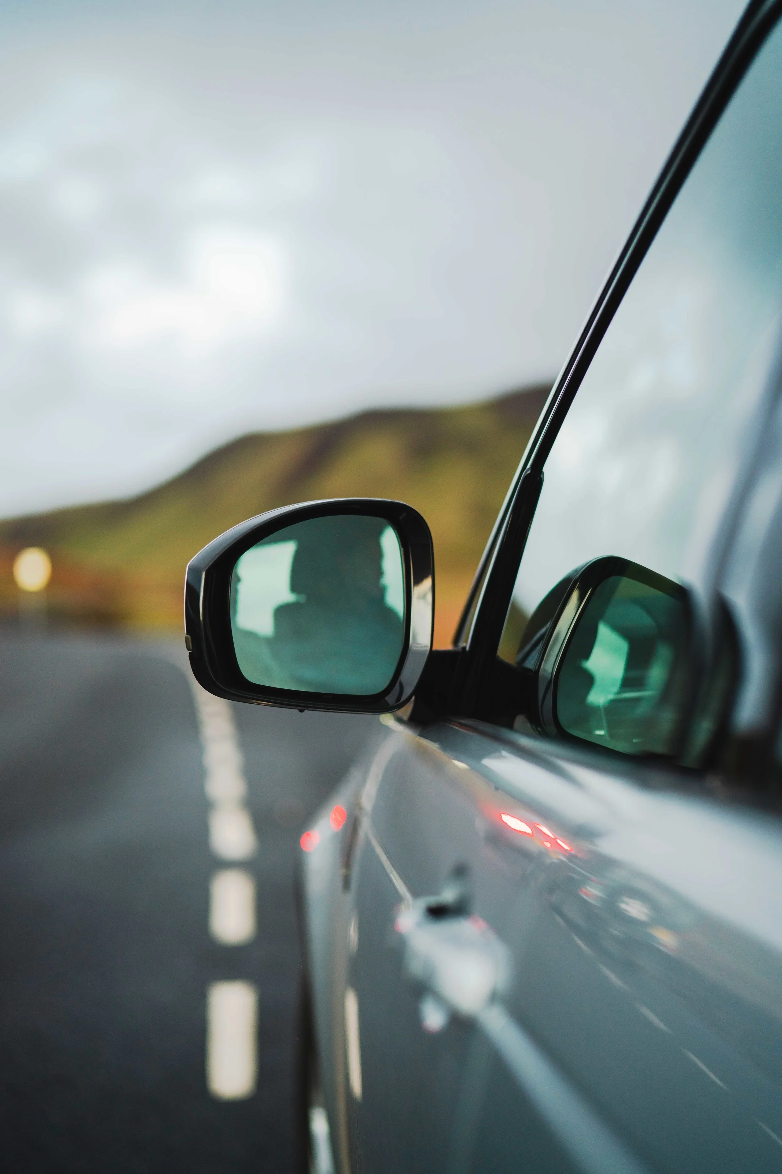 Land Rover Discovery side mirror view in Scotland.