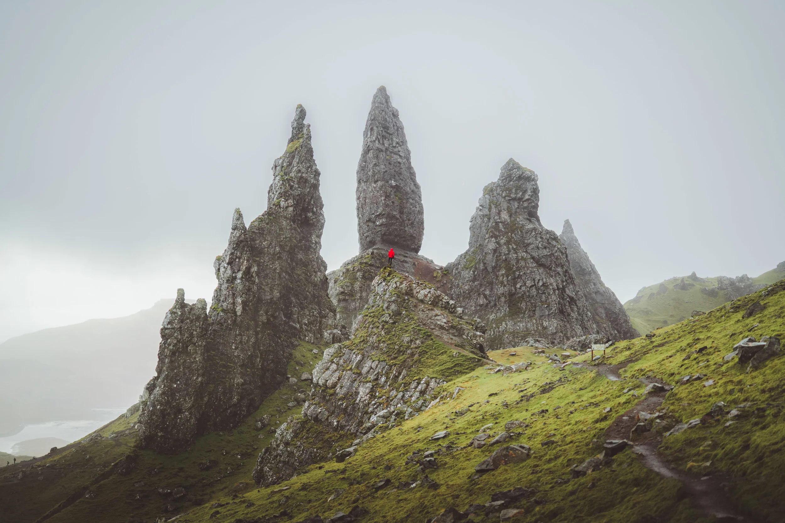 Man with red jacket in the rock of Old Man of Storr