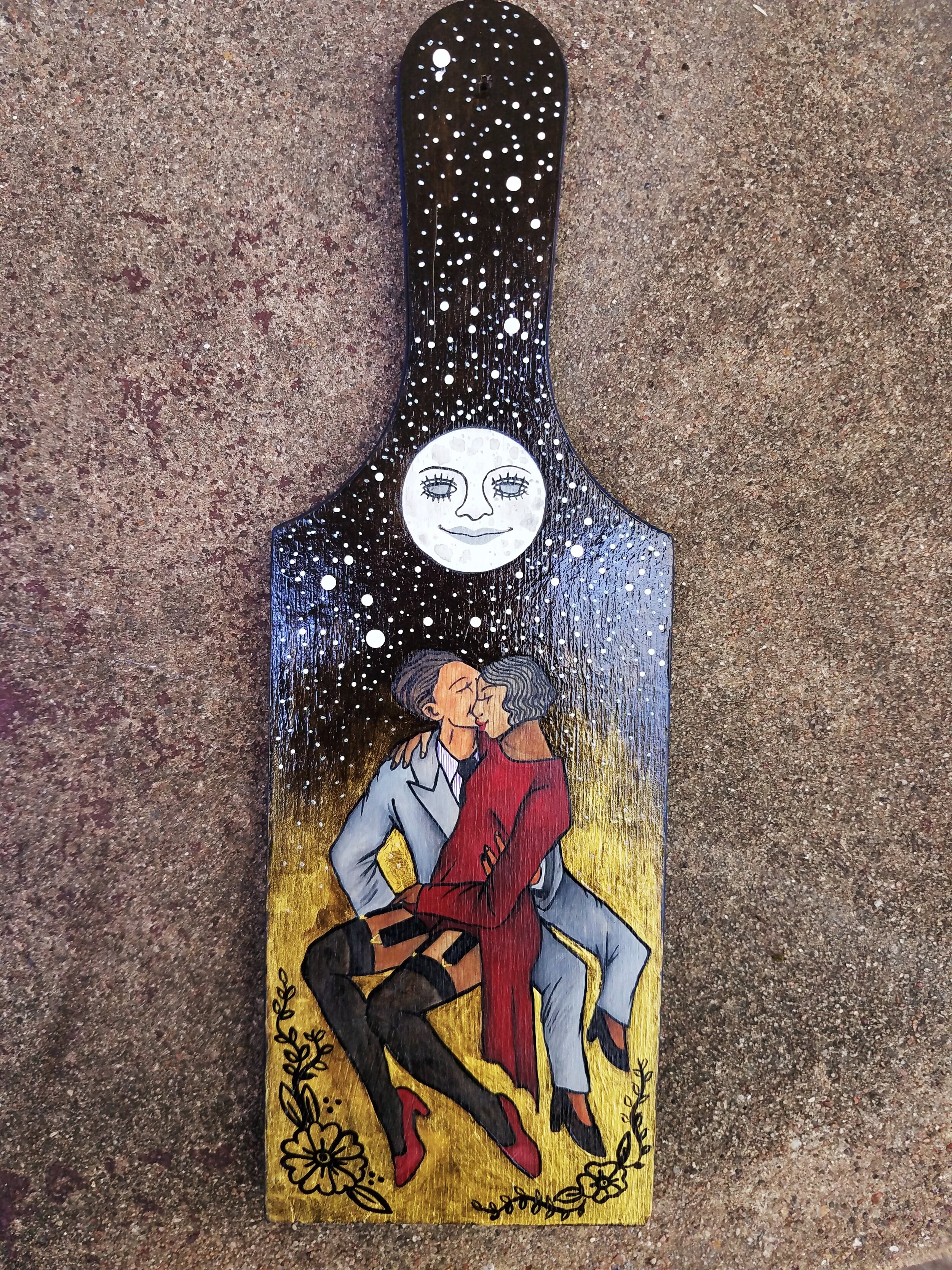  Acrylic paint and ink on wood paddle. 