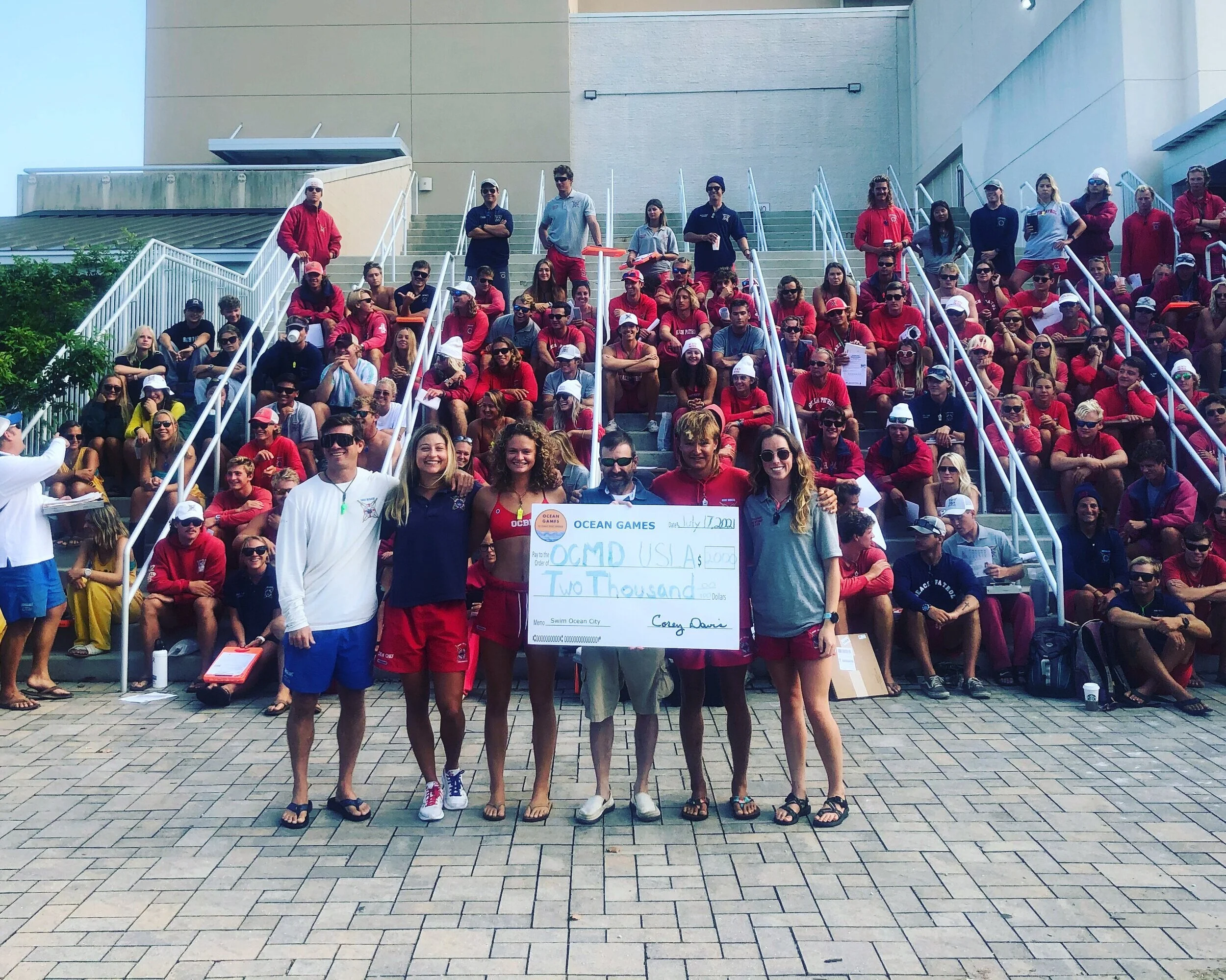 Corey Davis, President of Swim Ocean City, presents a $2,000 check to OCBP Chapter of USLA’s (Left to right: Travis Wagner, Sam Bingaman, Torrey Hurst, Corey Davis, Michael Young and Elaine Watts)