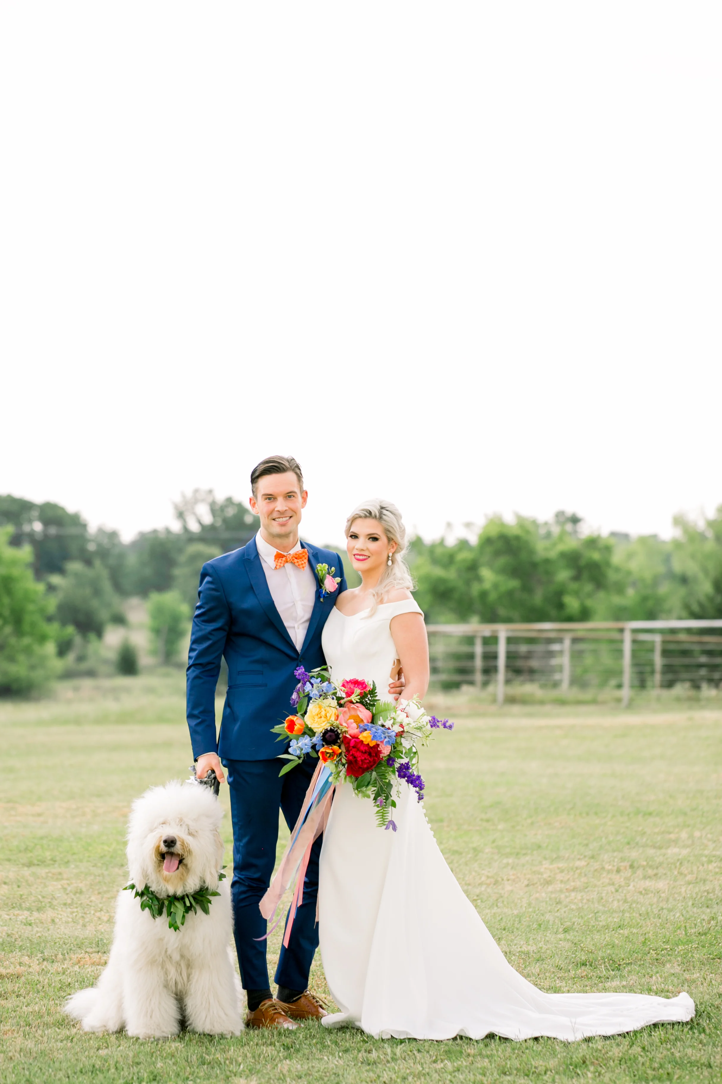 Bride and groom outside with dog