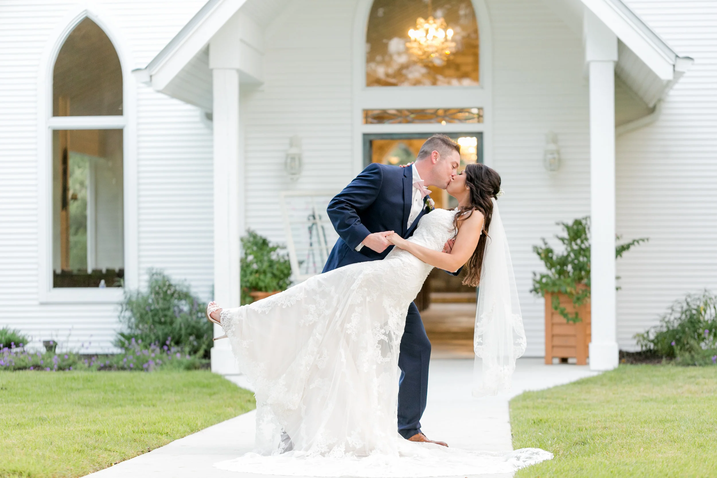 Bride and groom kiss in front of chapel