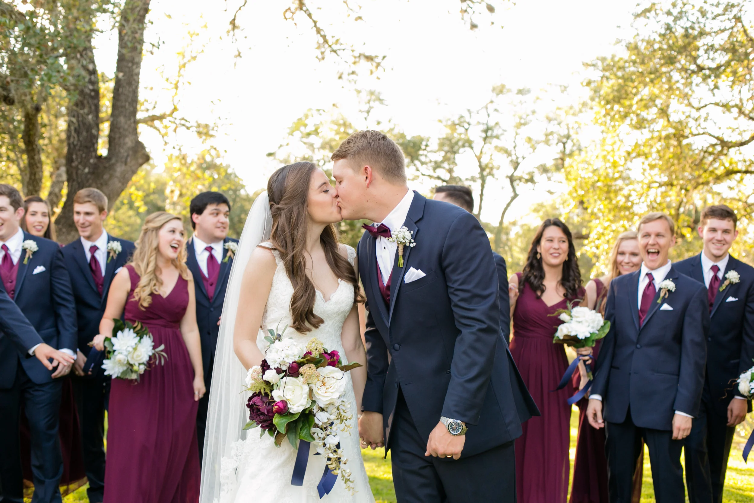 Bride, groom, and wedding party outside