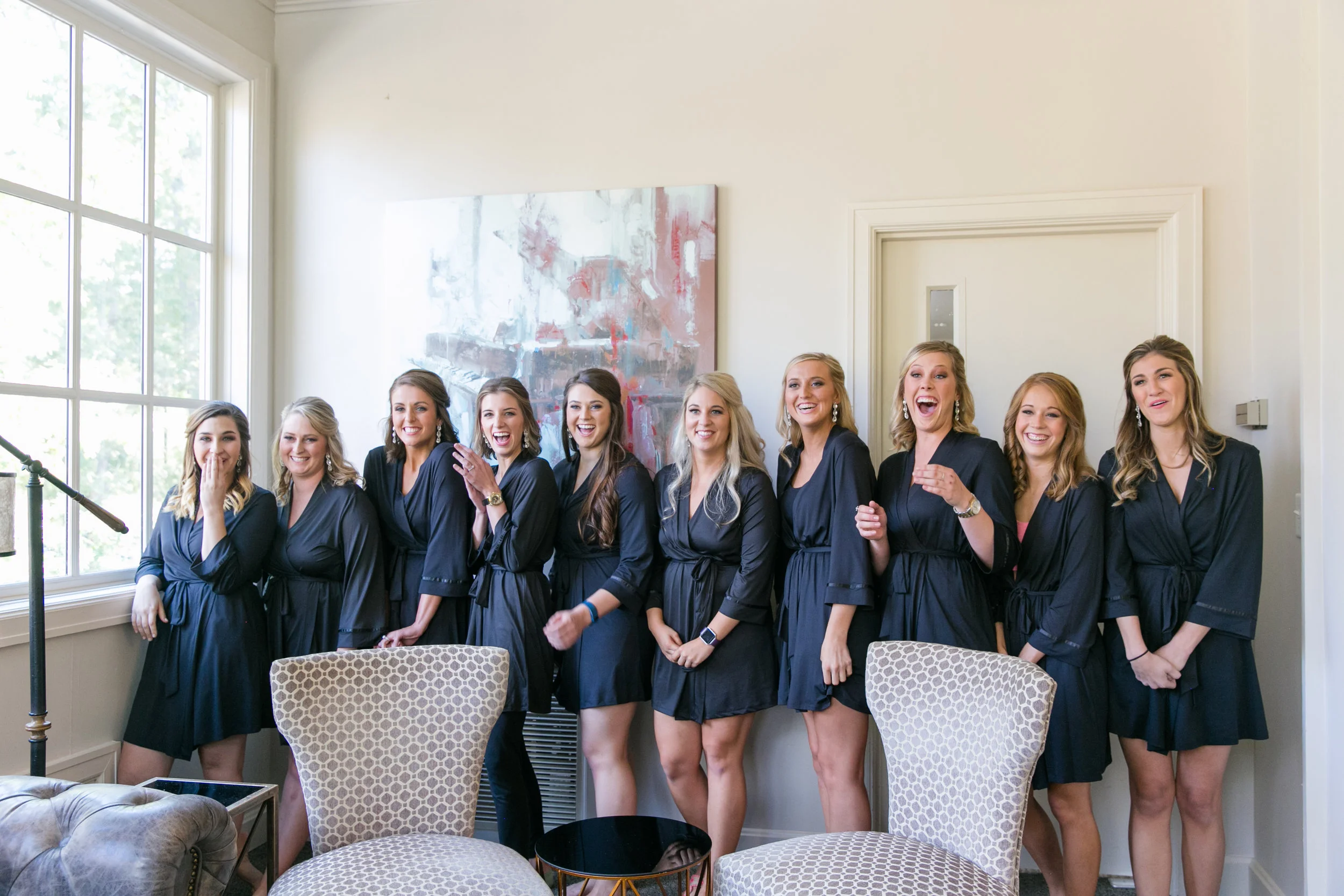 Bride and bridesmaids in matching robes getting ready