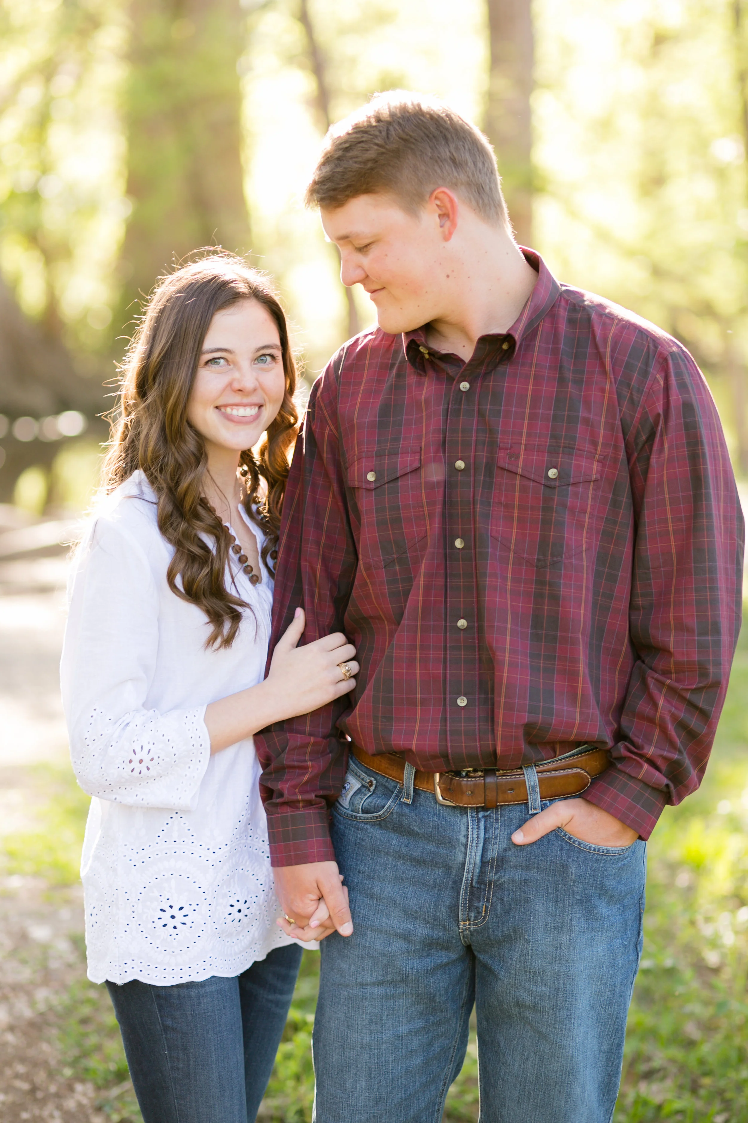 Couple holding hands outside in forest