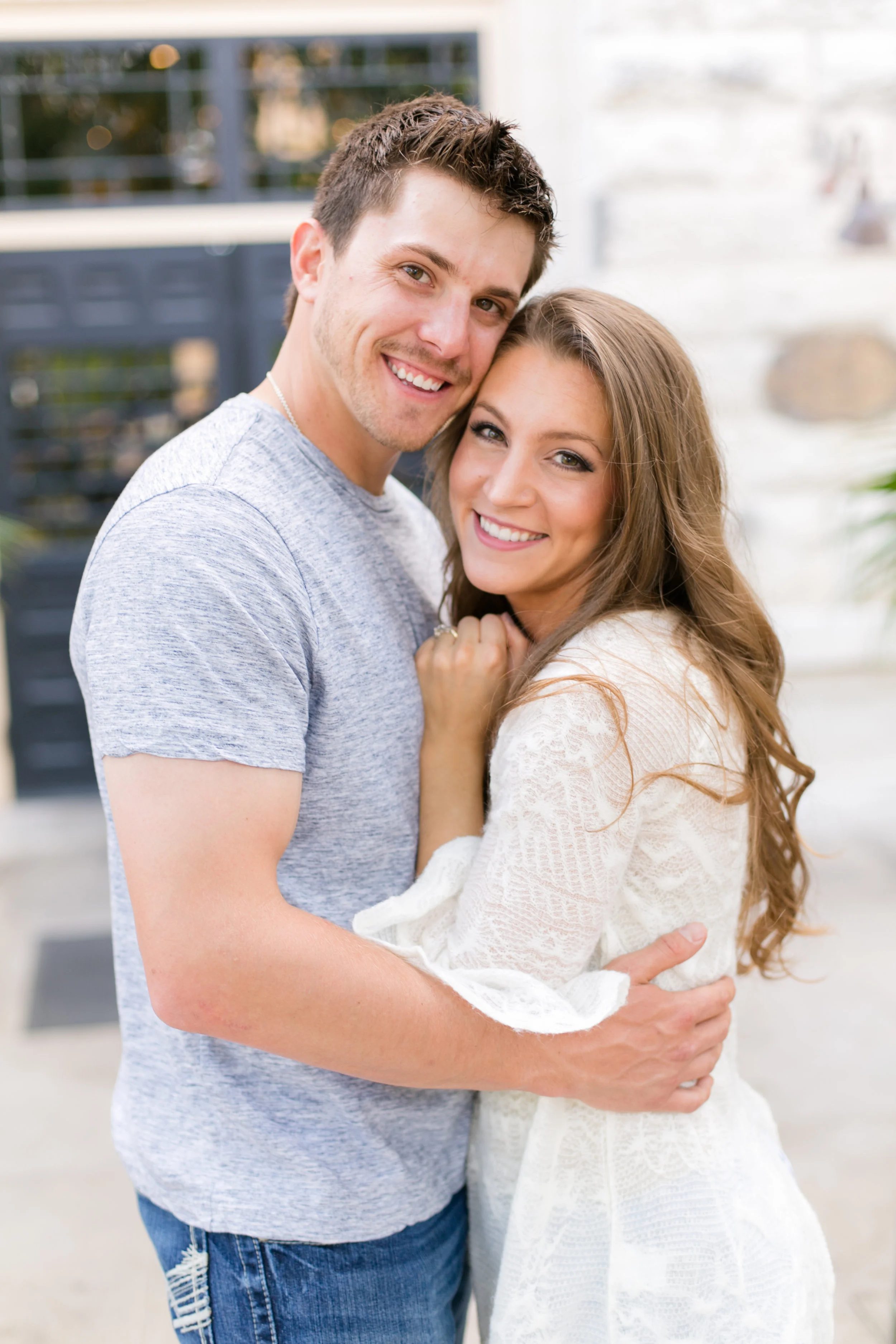 couple smiling light and bright outside downtown