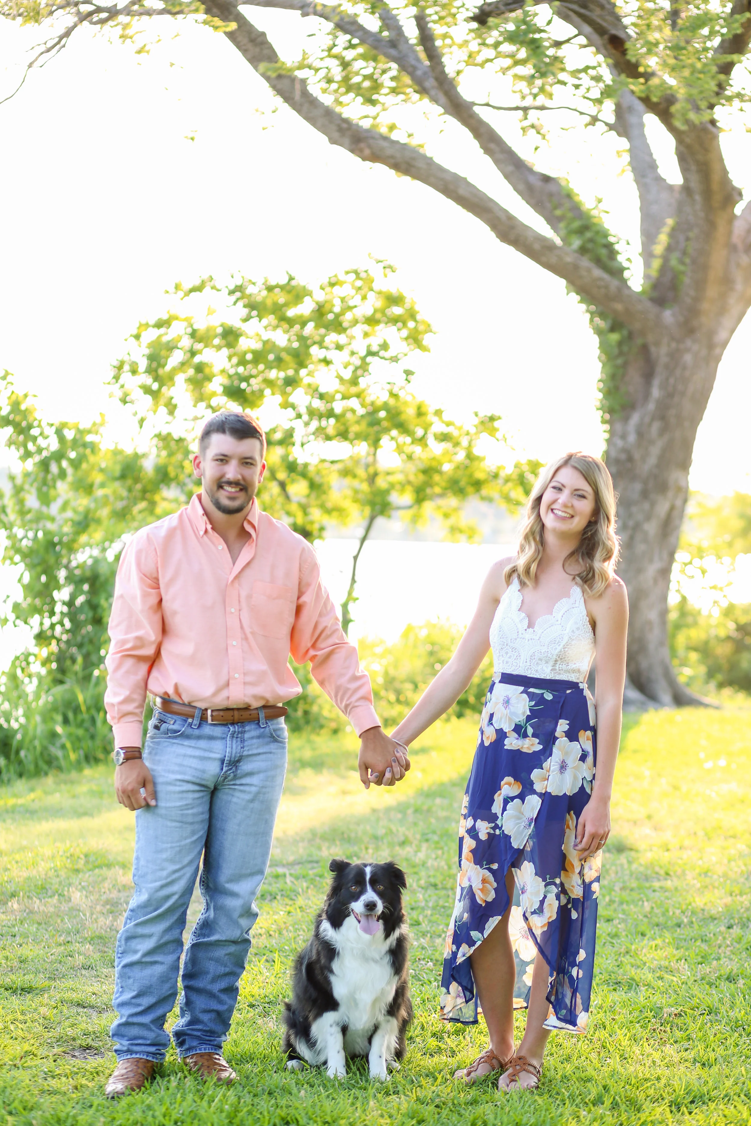 Couple with dog outside by lake