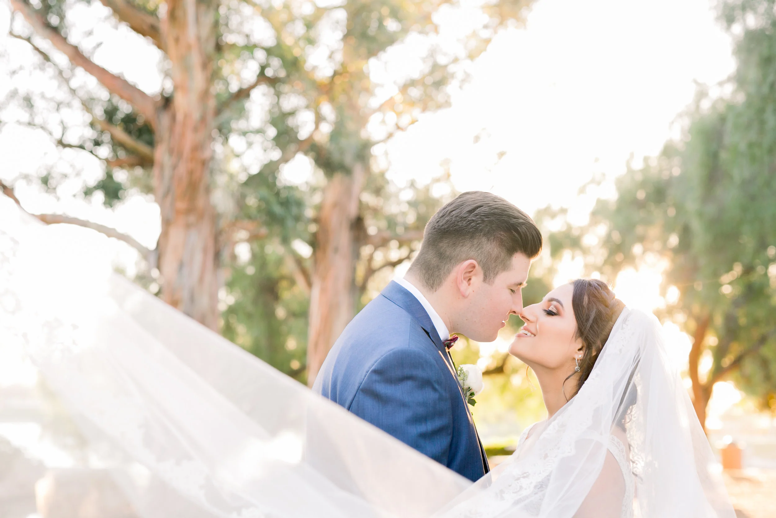 Bride & Groom with Floating veil at sunset