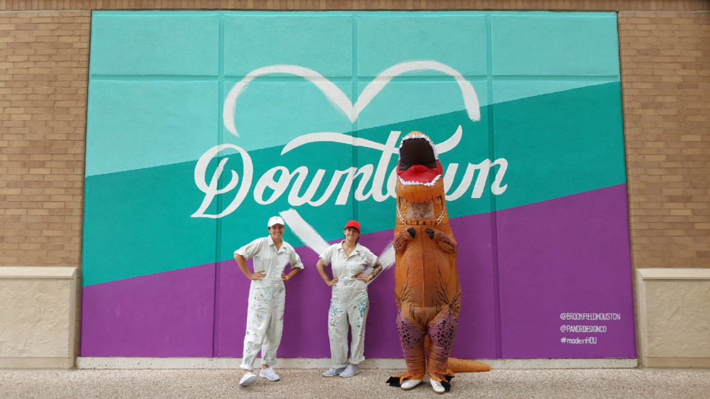 The Pandr Team with a Dino at the Custom Hand Painted Downtown Houston Heart Mural with Teal and Purple