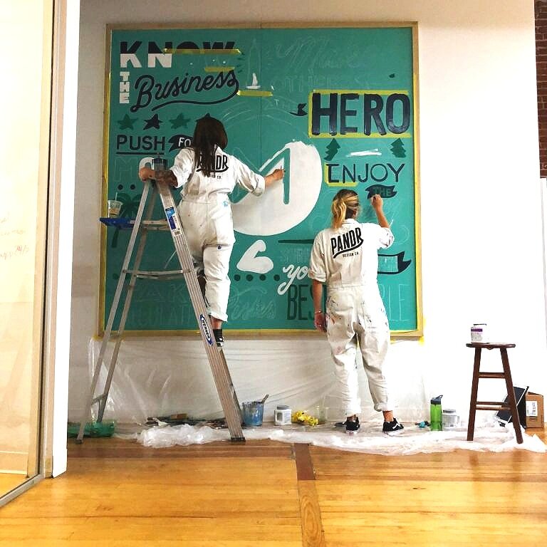 Custom Hand Painted Office Mural for Movement Strategy featuring inspiring words, icons, and phrases