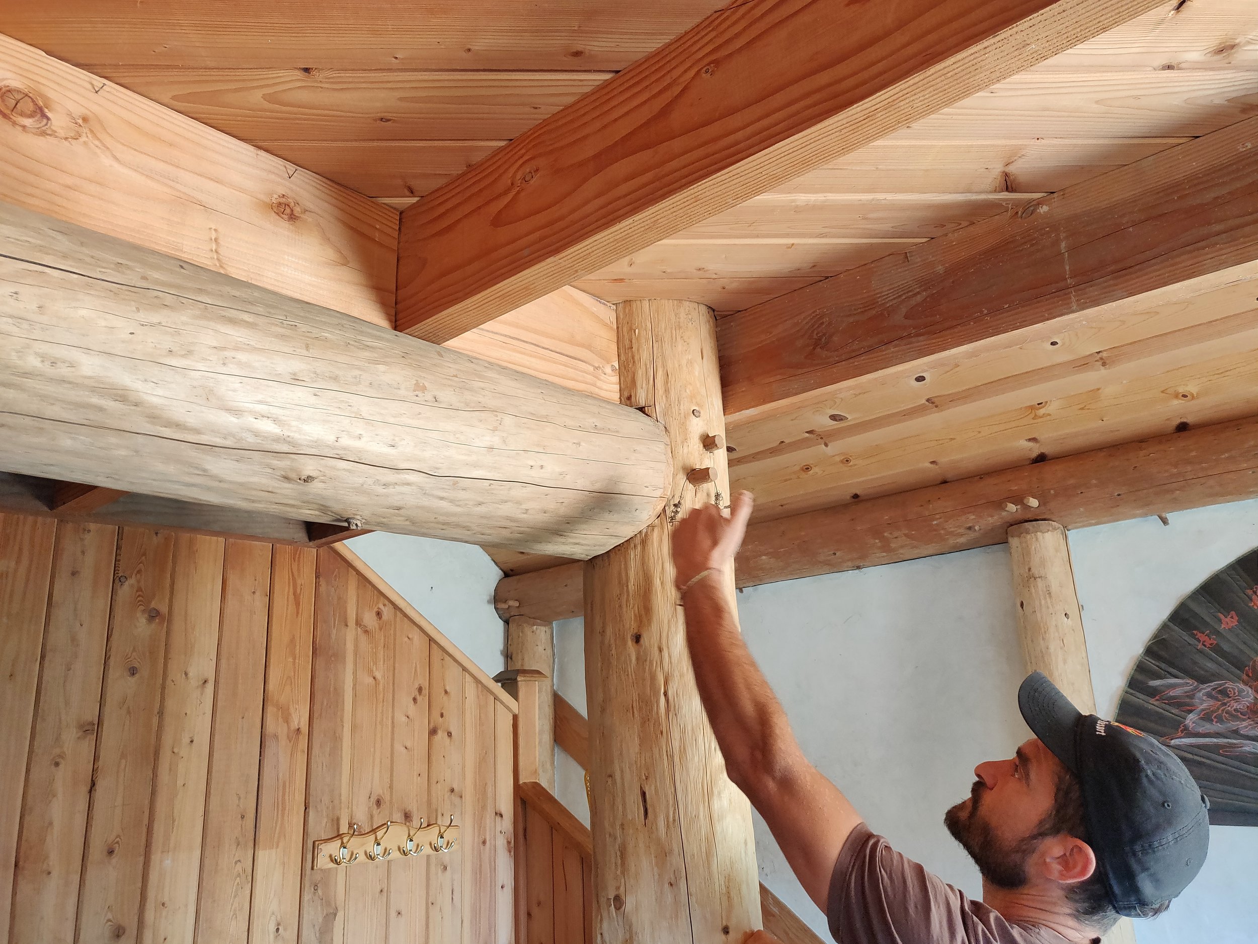  Collin Gillespie, of   Polecraft Solutions  , showing sturdy wood dowel joinery on the interior of a round wood framed, earth plaster home he helped to design. 