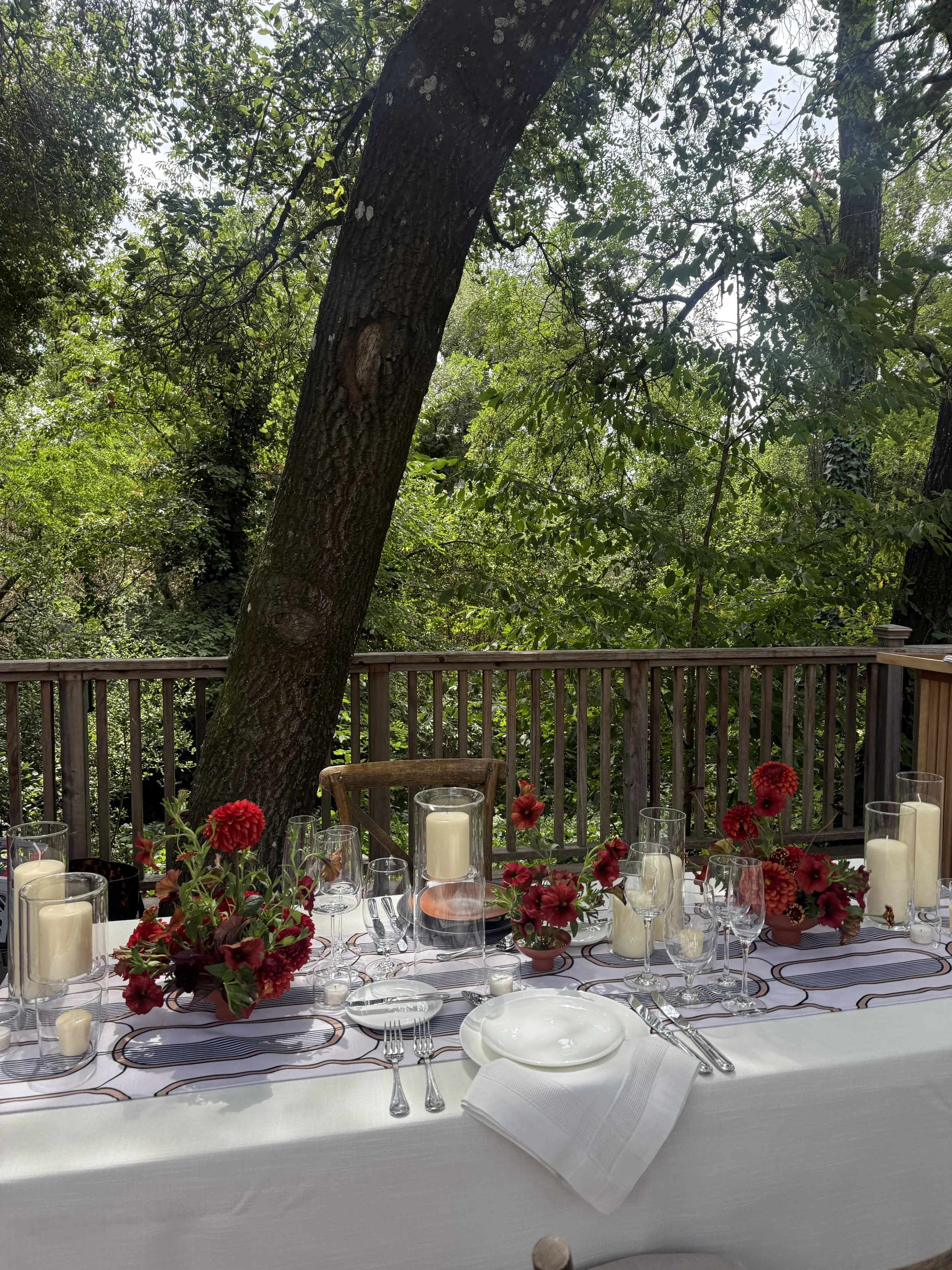 Outdoor wedding tablescape mockup with red florals, pillar candles, and white linens at The Madrona Healdsburg, styled with Caitlin Gutierrez Events.JPG