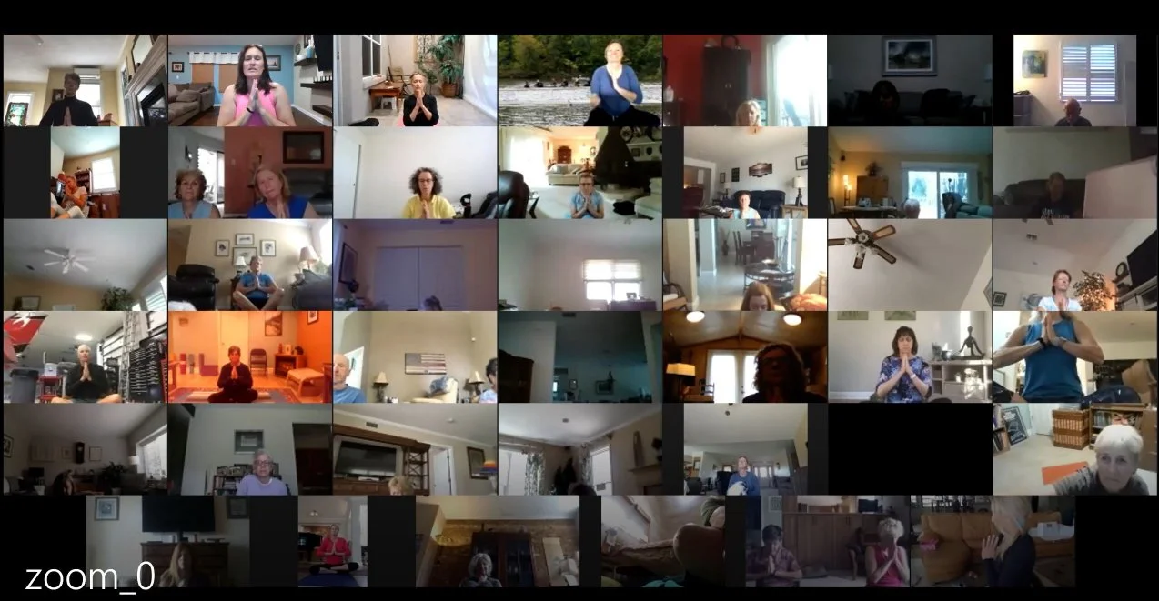 Online yoga students practicing together in a Zoom class.