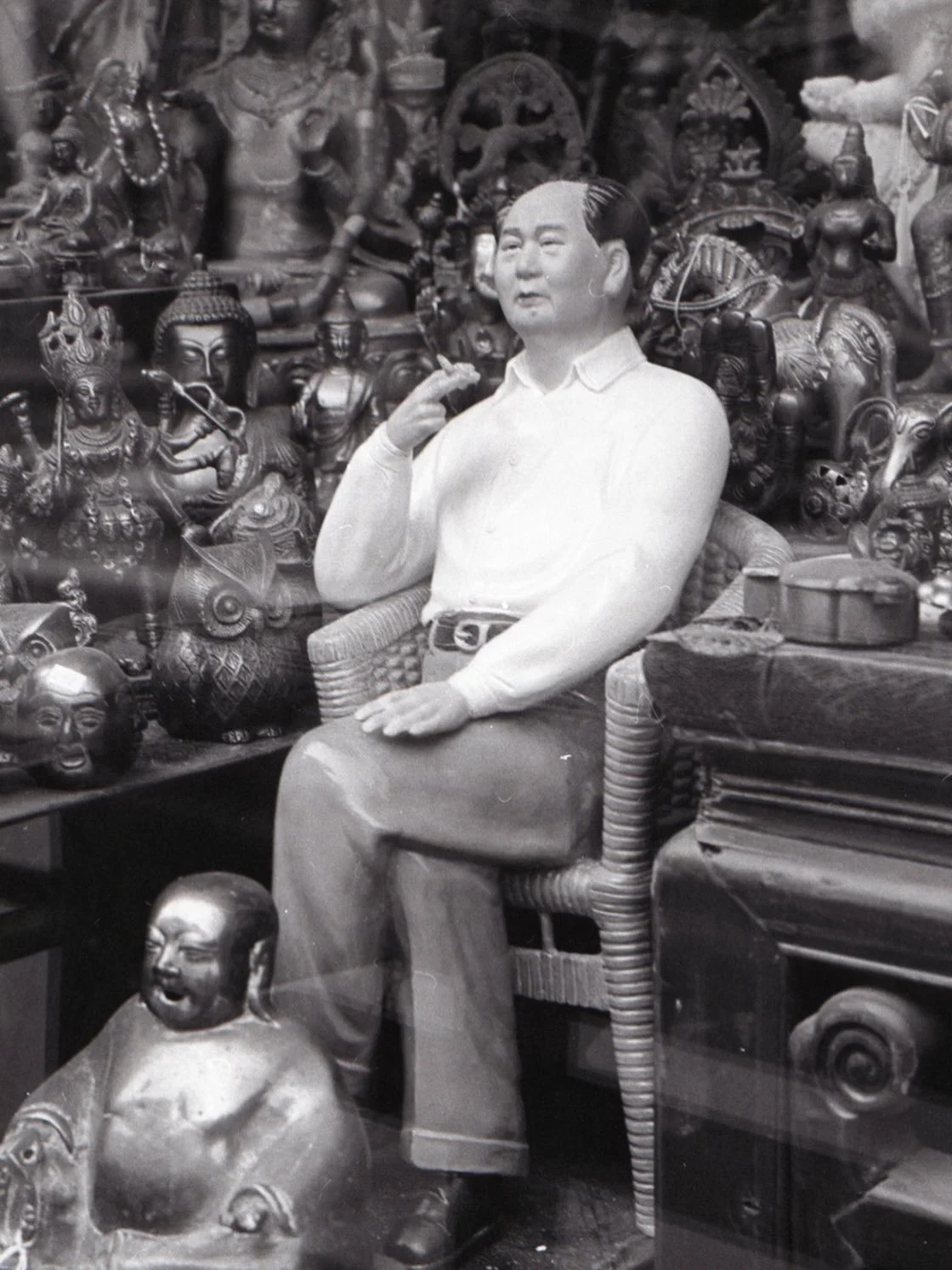 Chairman Mao disdainfully ignoring various deities whilst defiantly smoking a cigarette. Shop window. Portobello Road. London. Very sacrilegious stuff #rolleiflex #filmphotography #blackandwhitephotography