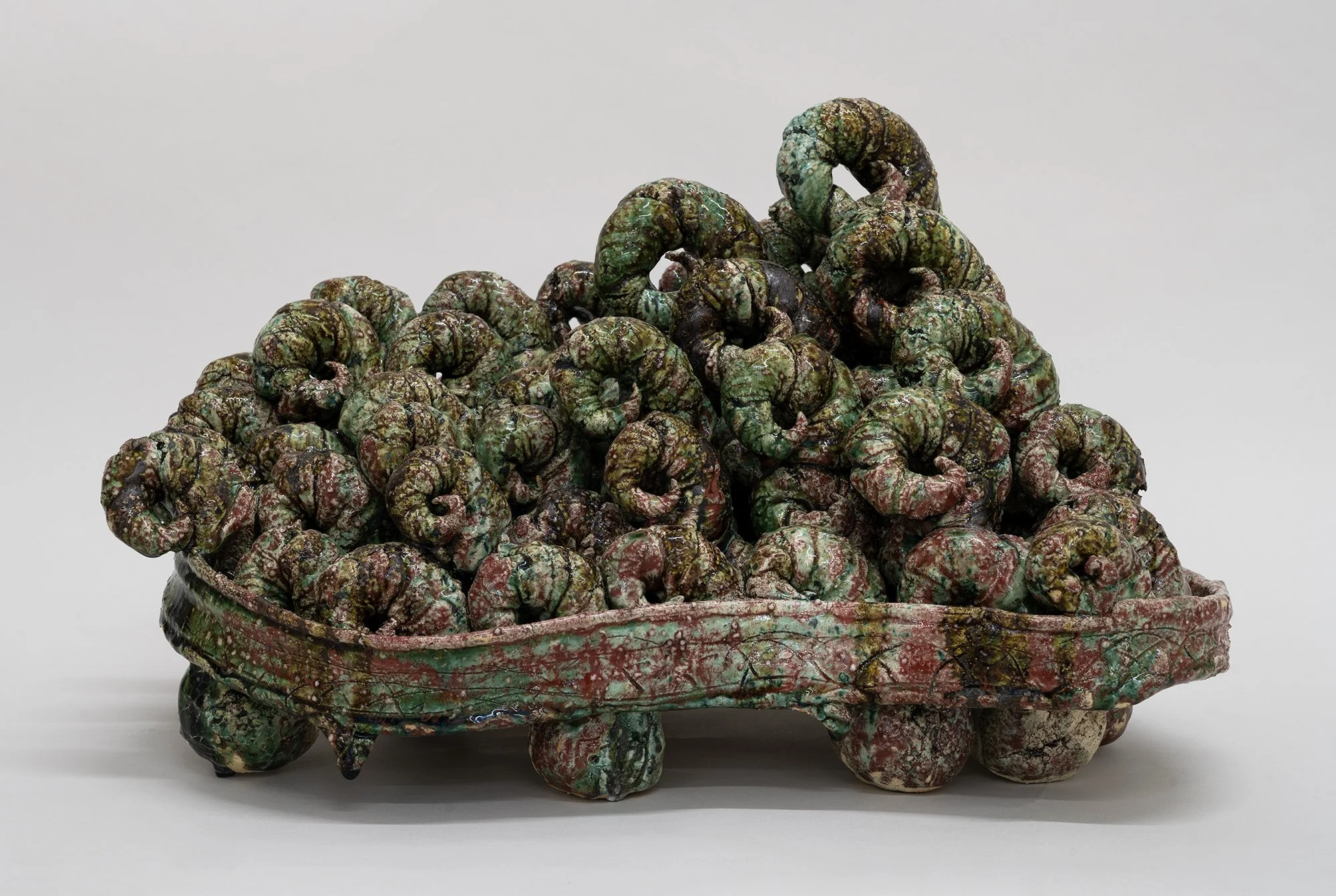 Tray with Clouds , 2025 Sang de boeuf Oribe Reduced stoneware with feldspathic and hagi sand inclusions, copper saturate glaze, pine needle ash, post-firing acid soak 33 x 54 x 39 cm