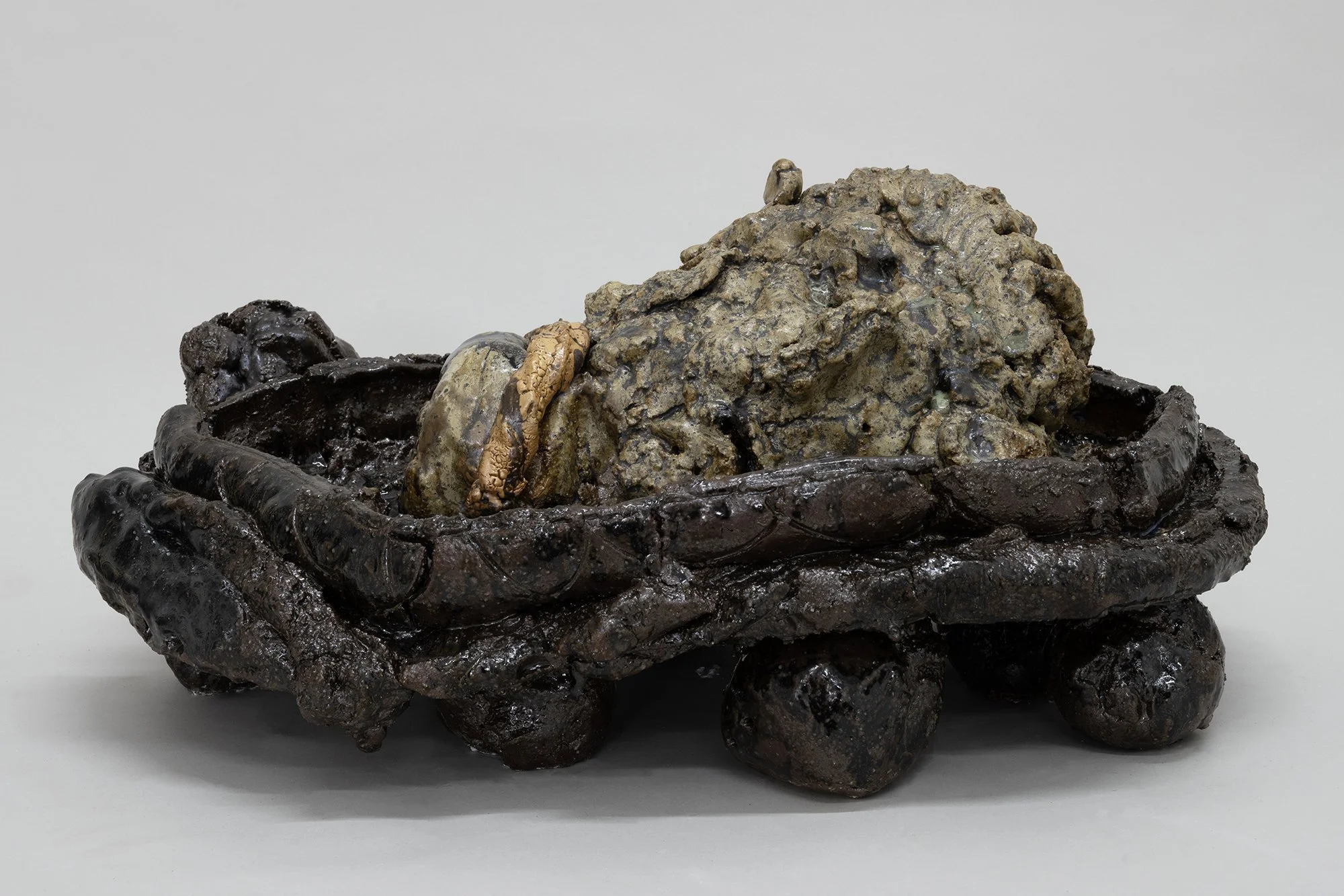 Tray with Head , 2025 Reduced English stoneware with iron and feldspathic inclusions, reconstructed song ‘tianmu’ and polychrome glazes 23 x 53 x 34 cm