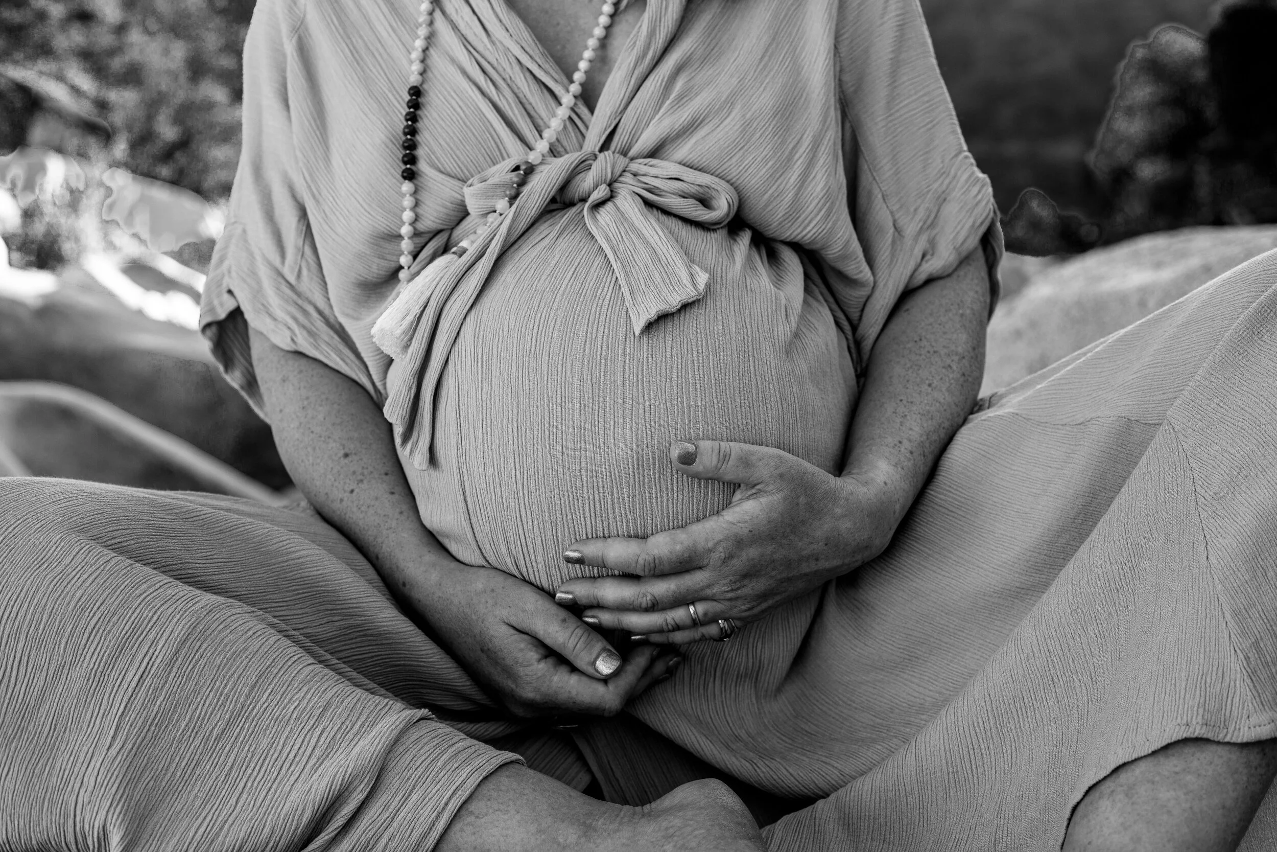 An image of a pregnancy belly at the river