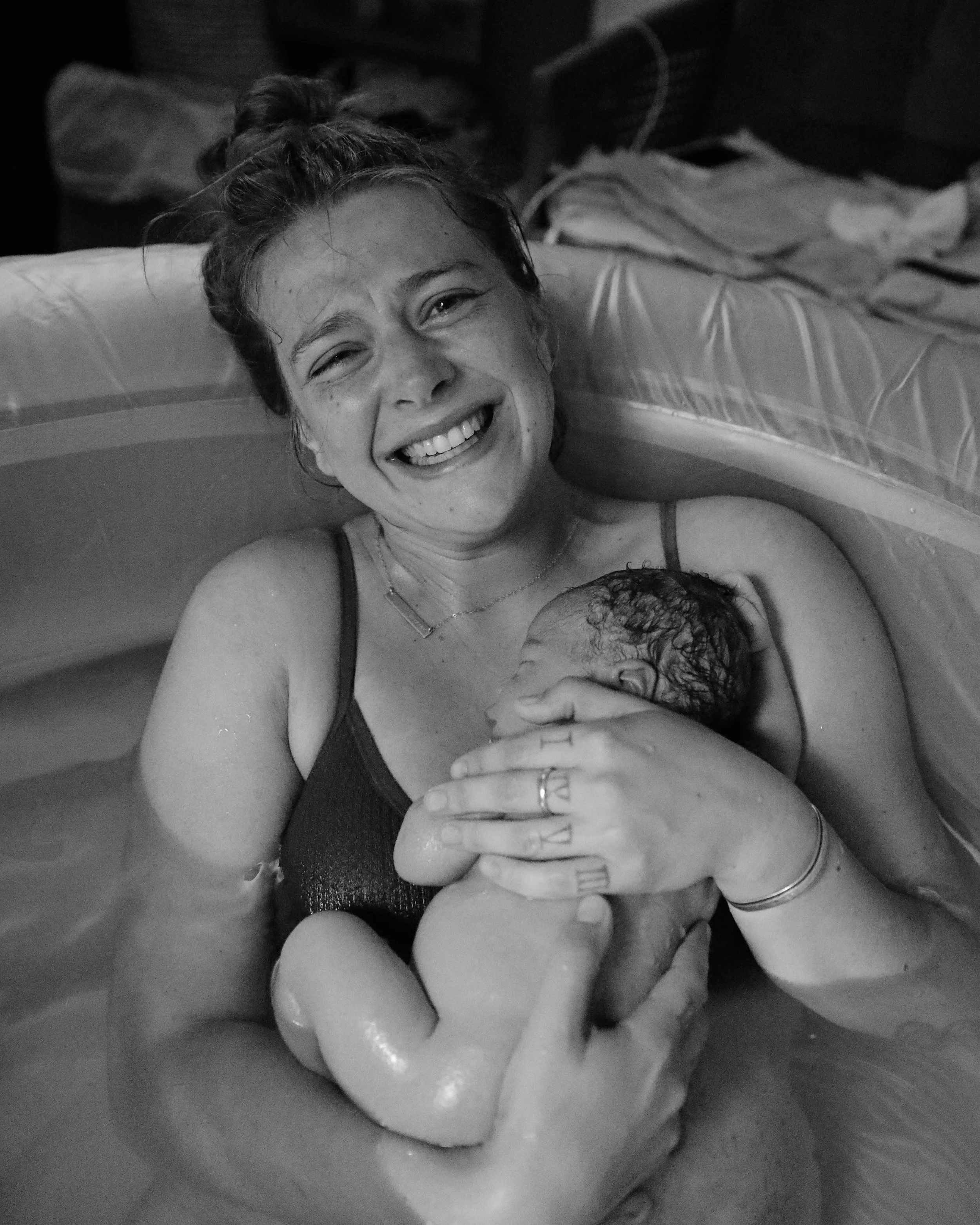 image of a mother and her newborn baby in a birth tub