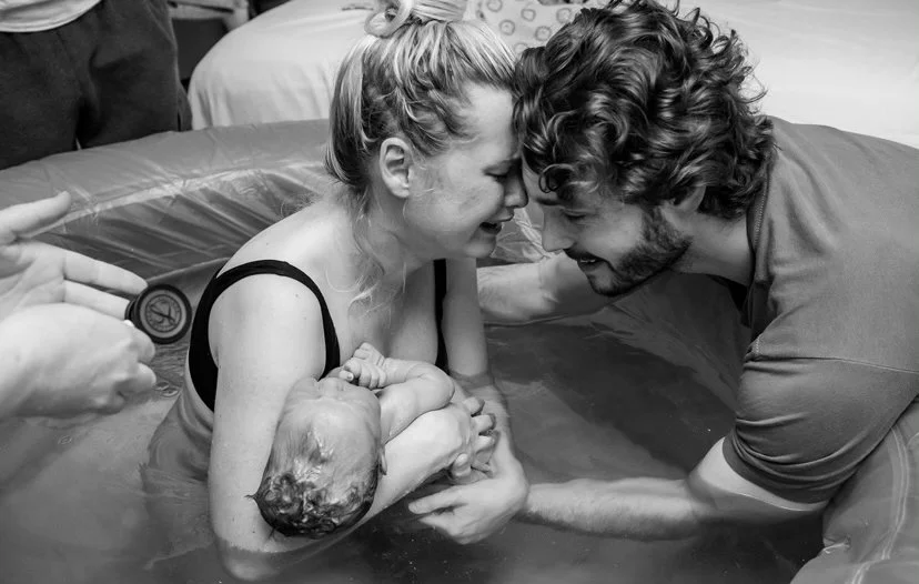 image of a water birth just after the baby has been born