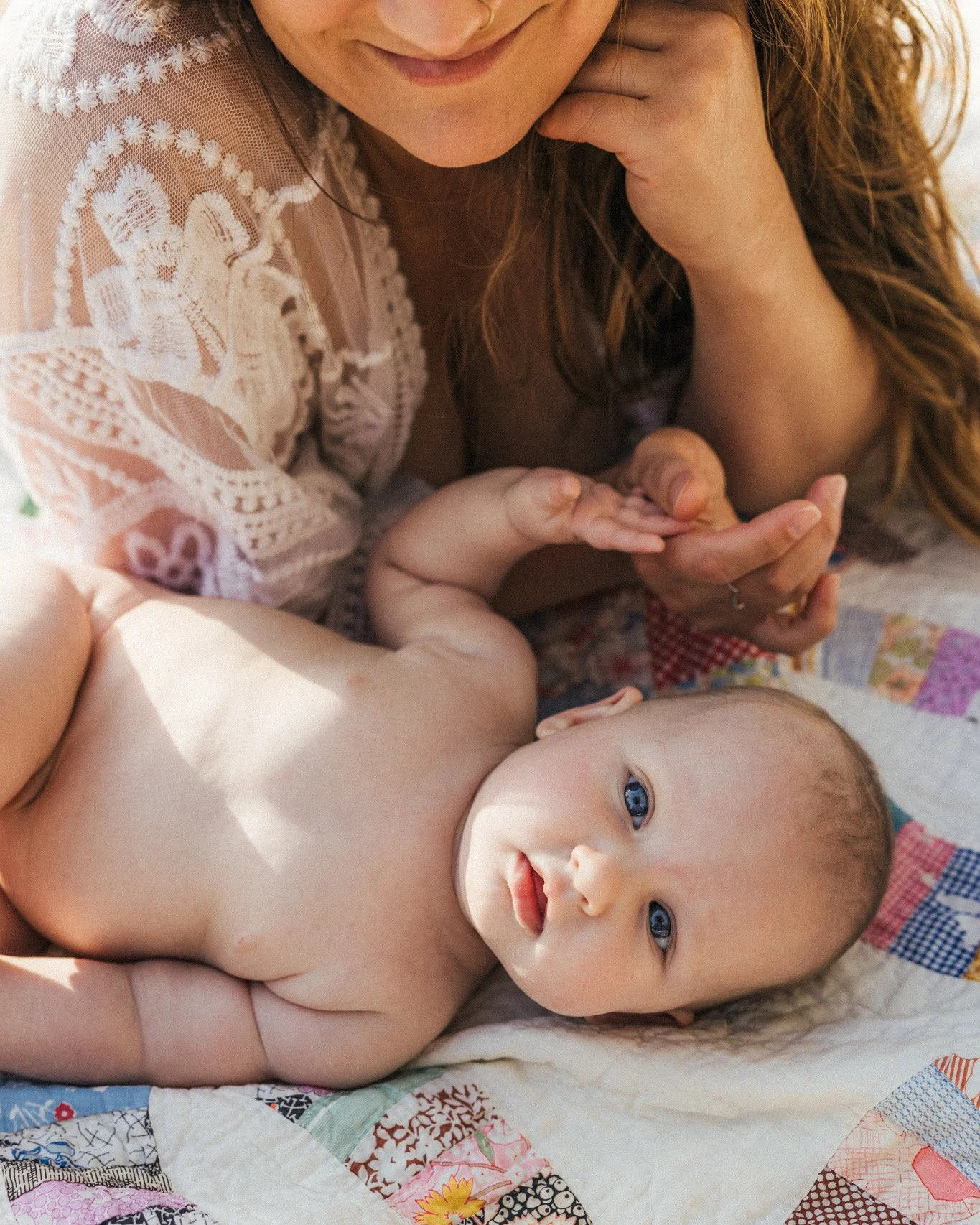 image of a blue eyed baby and her mother