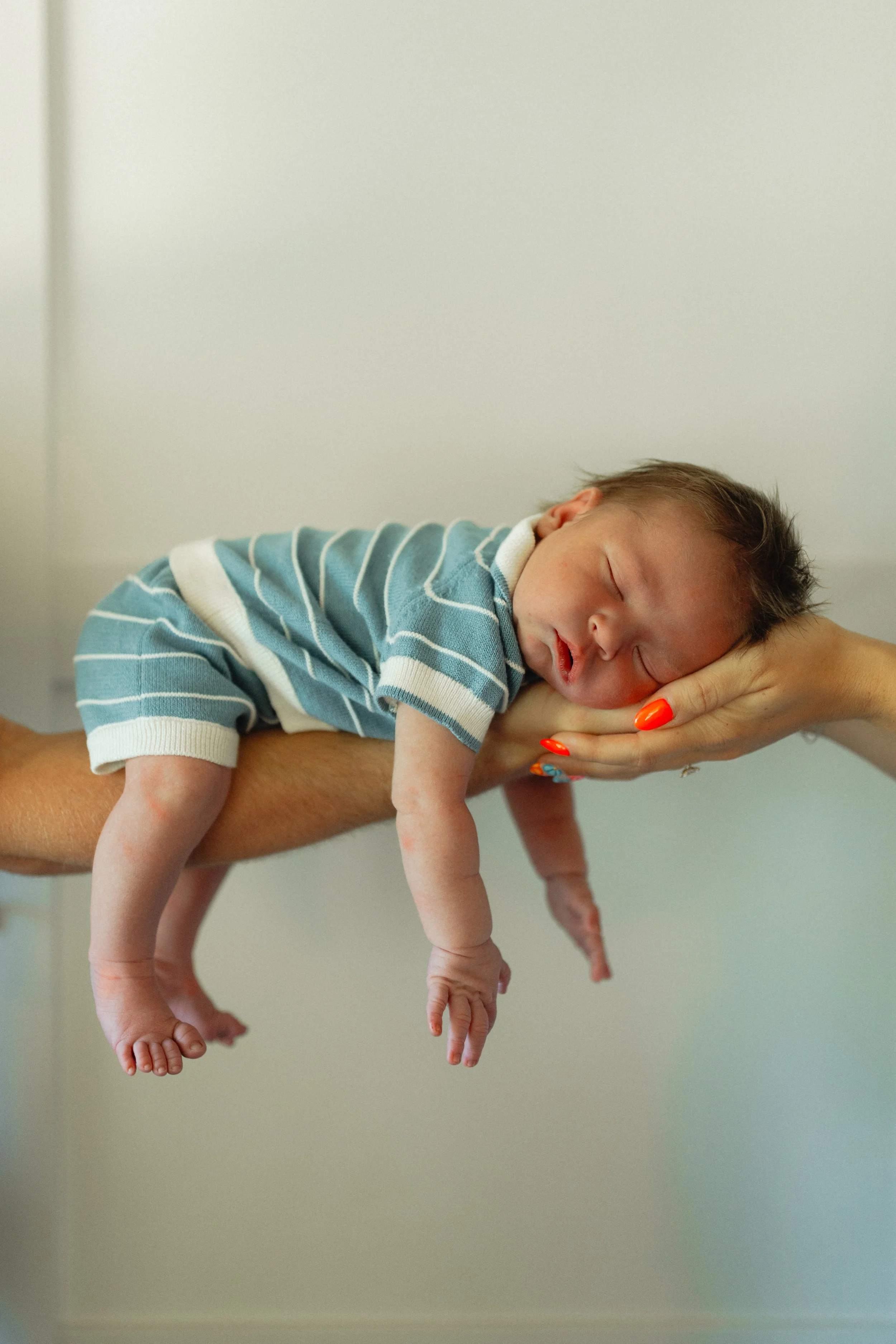 image of a newborn baby in his parents arms