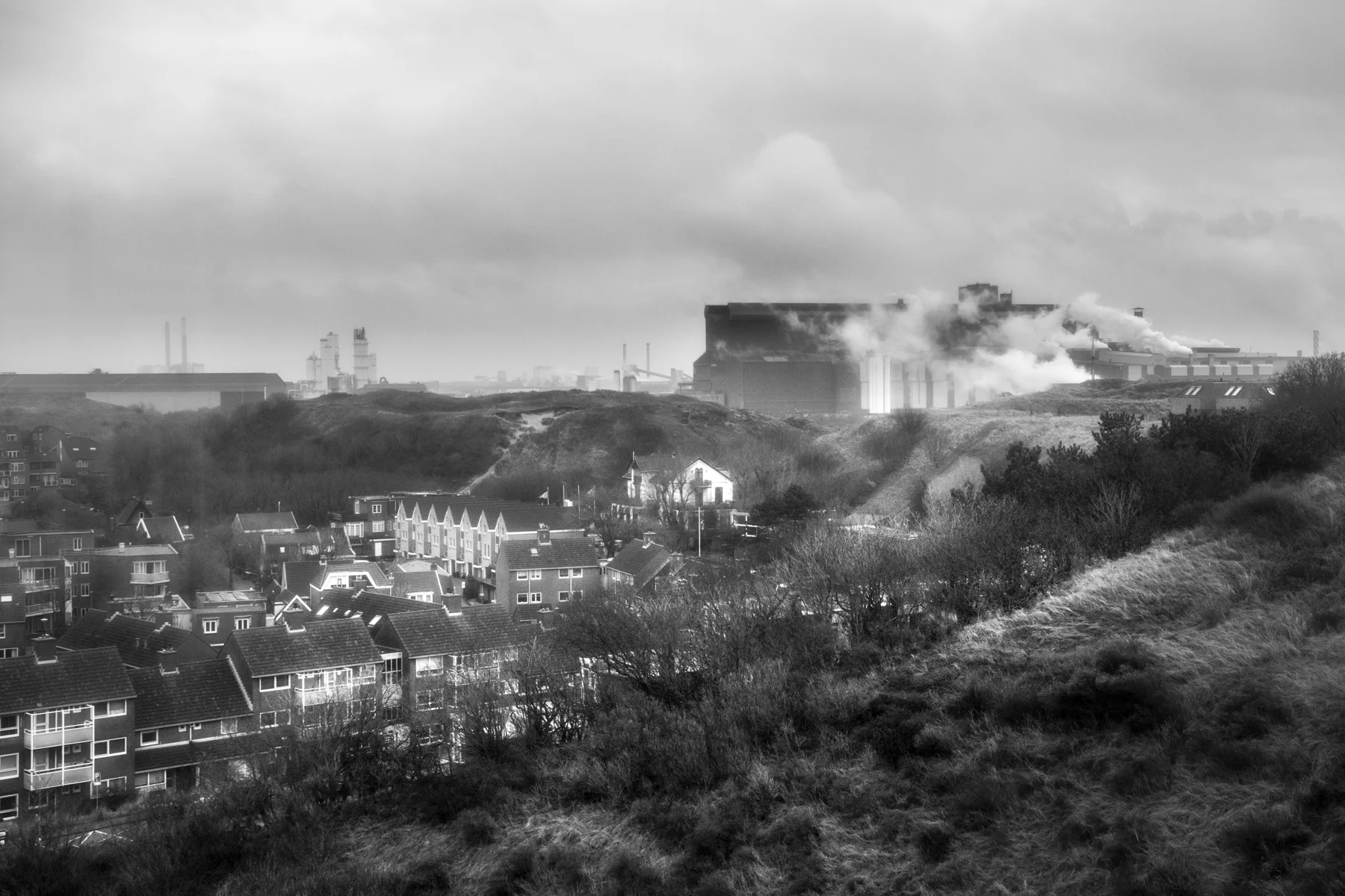 The other point was to visually cover the relation between the small village and the factory. We climbed up dunes with Sauw to reach the key point where you could clearly see the factory stretching the village but it was suddenly not possible to access due to fresh fences (In the middle of nowhere..). We went to a further but higher place close by, a hotel that let me photograph from their terrasse.