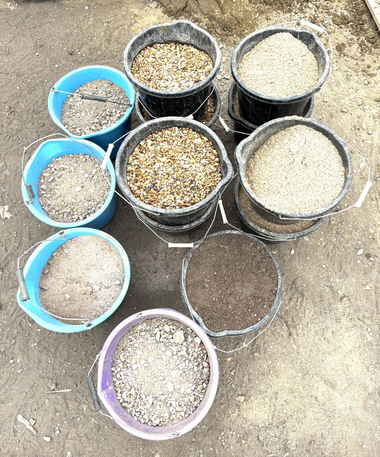 buckets of rammed earth materials, sand, stone, soil, clay