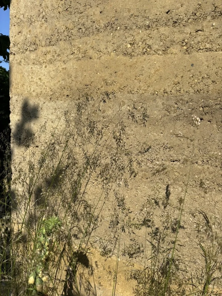rammed earth wall now dry showing the layers