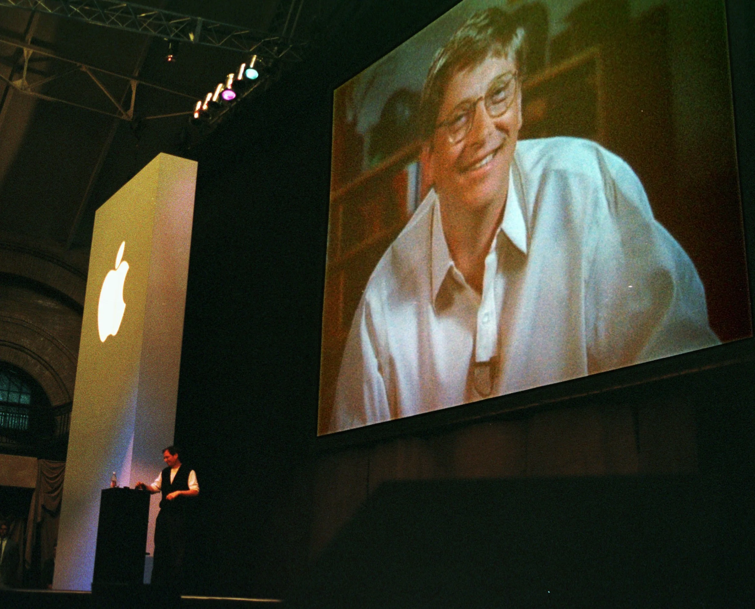 Bill Gates hovering over Jobs at MacWorld Boston 1997 .