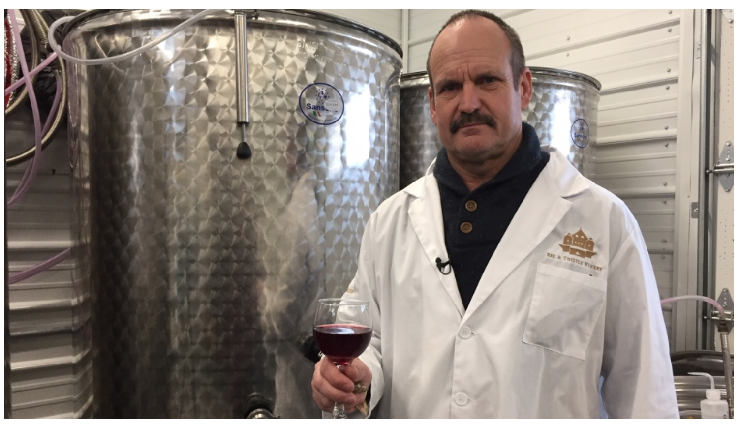 Peter MacInnis samples the first batch from the Bee and Thistle Winery.
