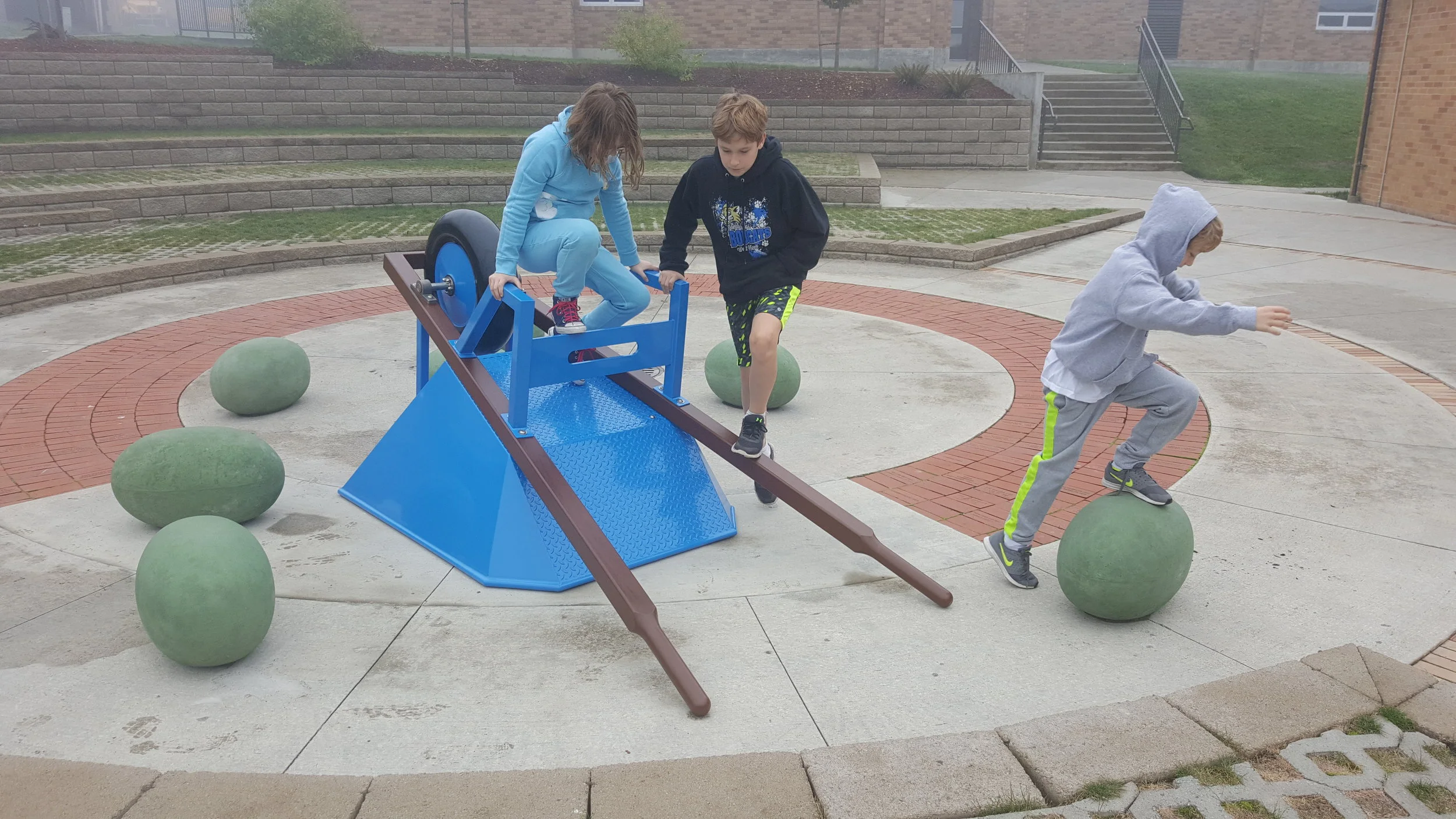 Kids can't resist the playful aspect of the installation, even on a foggy winter morning.
